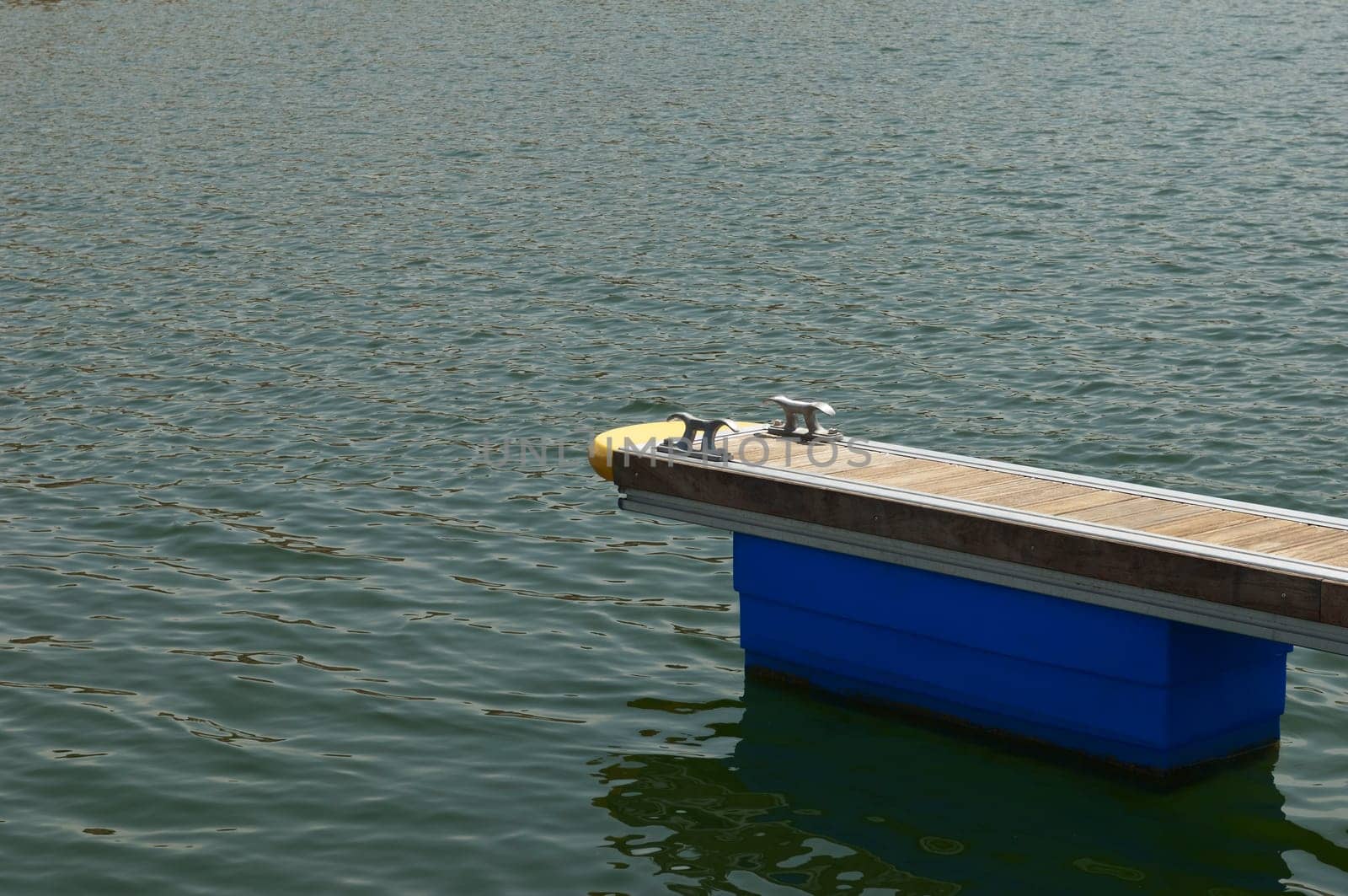 Detail of a wooden floating dock with mooring bitts