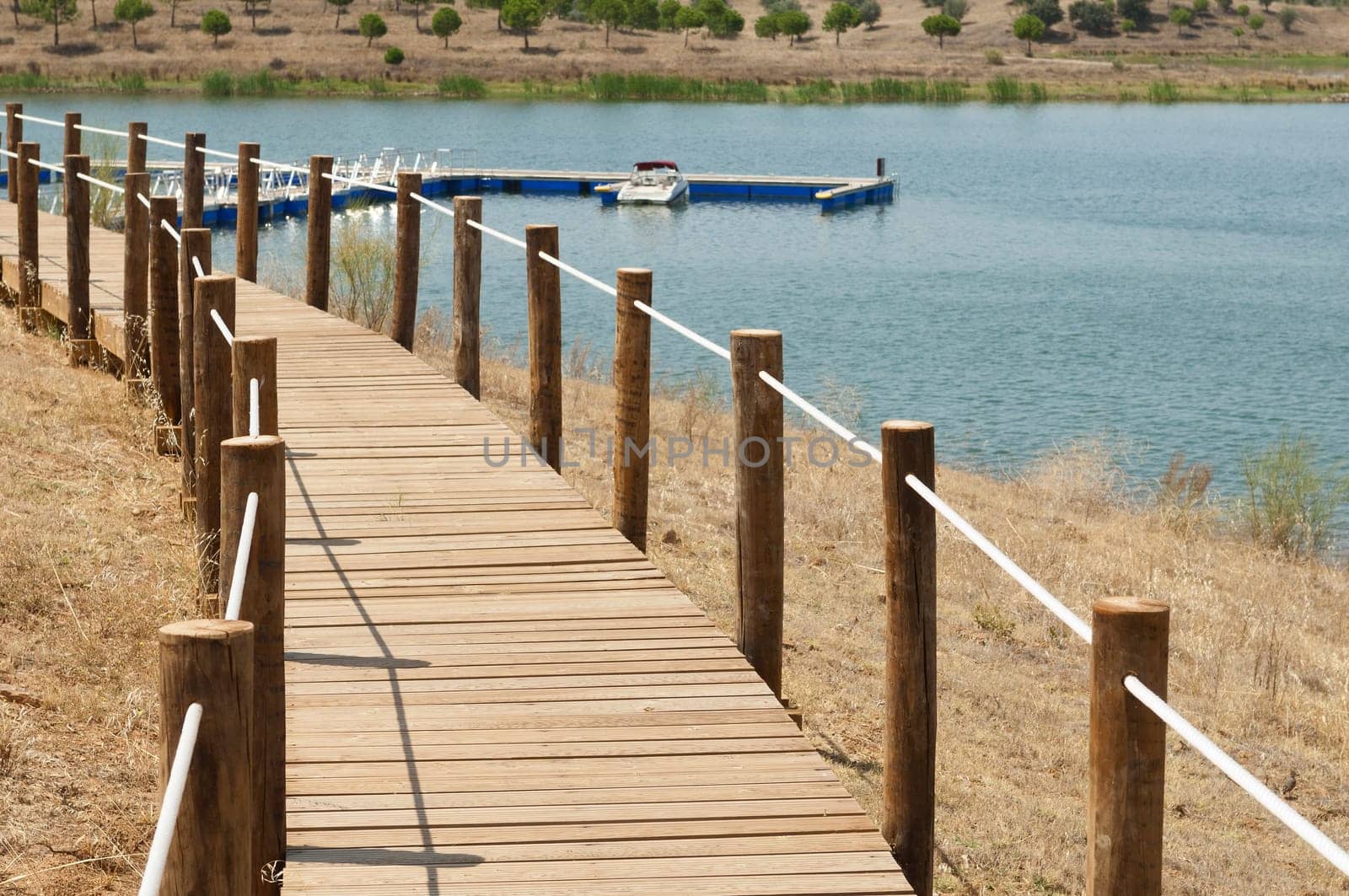 Wooden walkway serving Amieira pier on the banks of the reservoir of Alqueva, Alentejo, Portugal