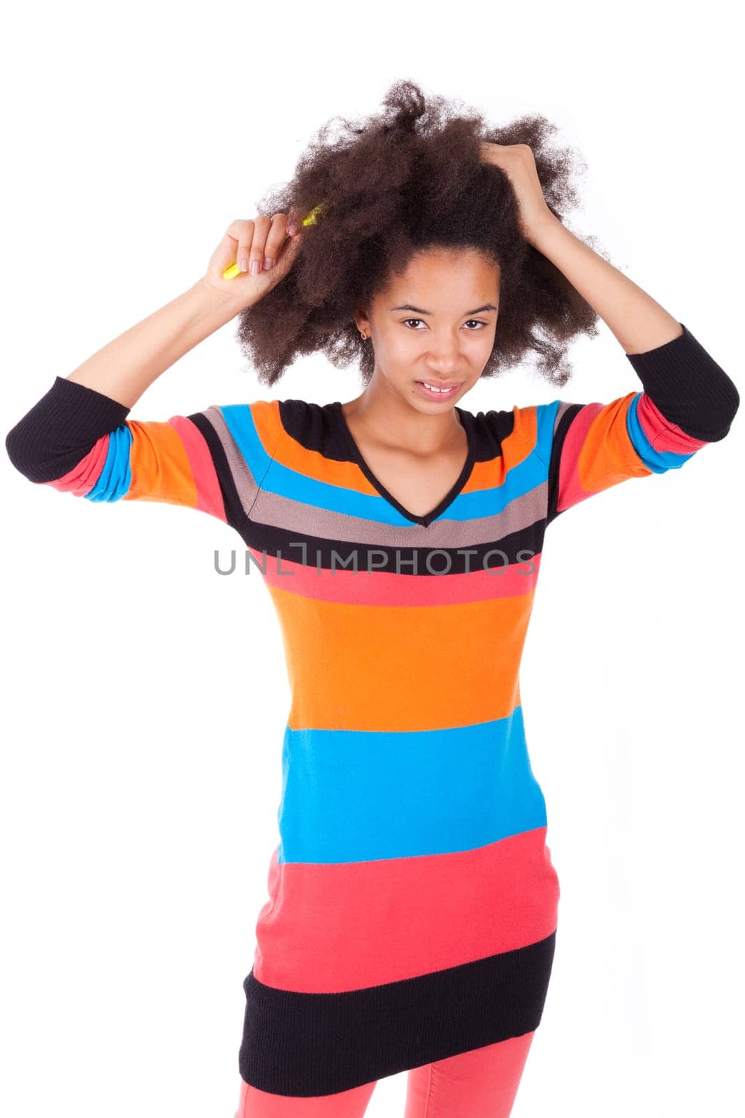 Black African American teenage girl combing her afro hair, isolated on white background
