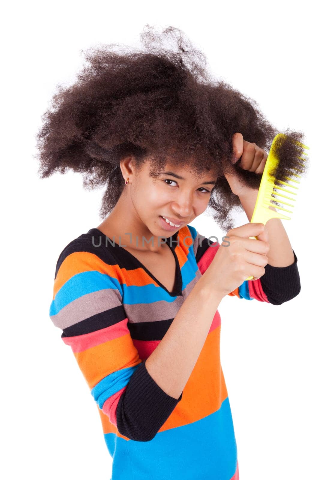 Black African American teenage girl combing her afro hair, isolated on white background