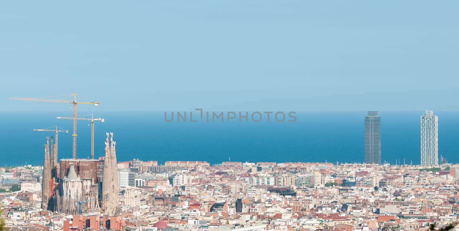 Panorama of Barcelona cityscape with Sagrada Familia  in foreground and sea in background. Barcelona, Catalonia, Spain, Europe.