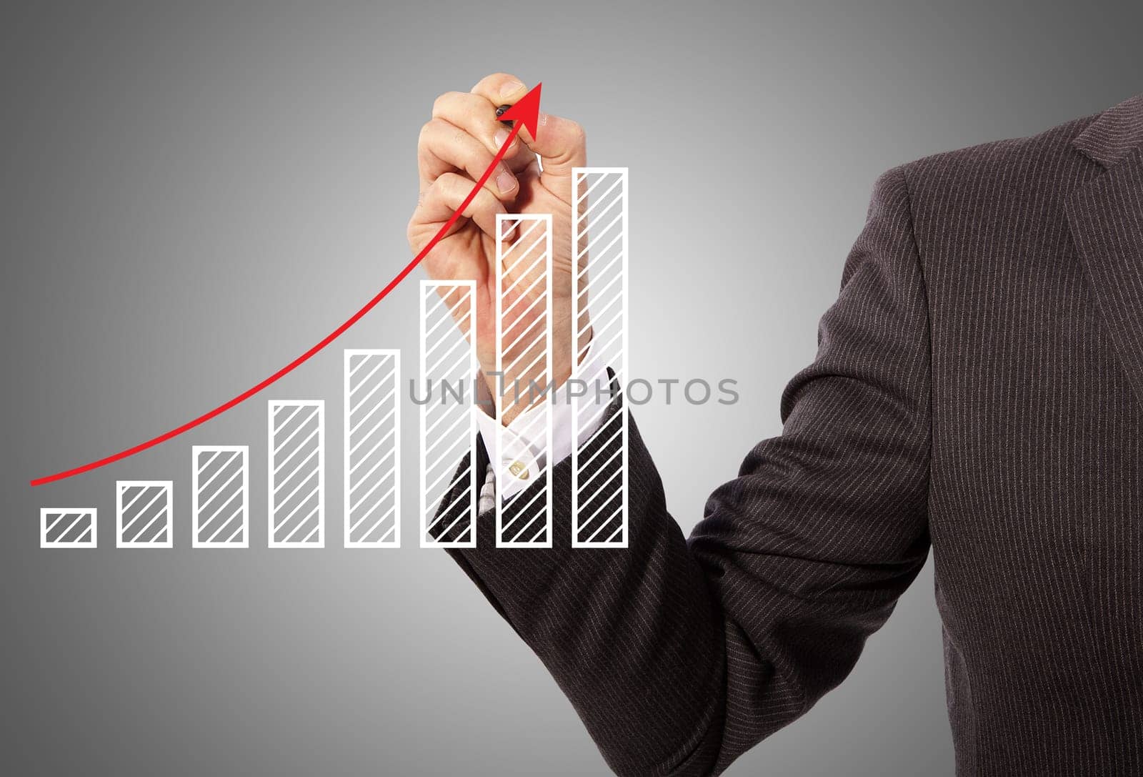 Male hand drawing a graph, grey background