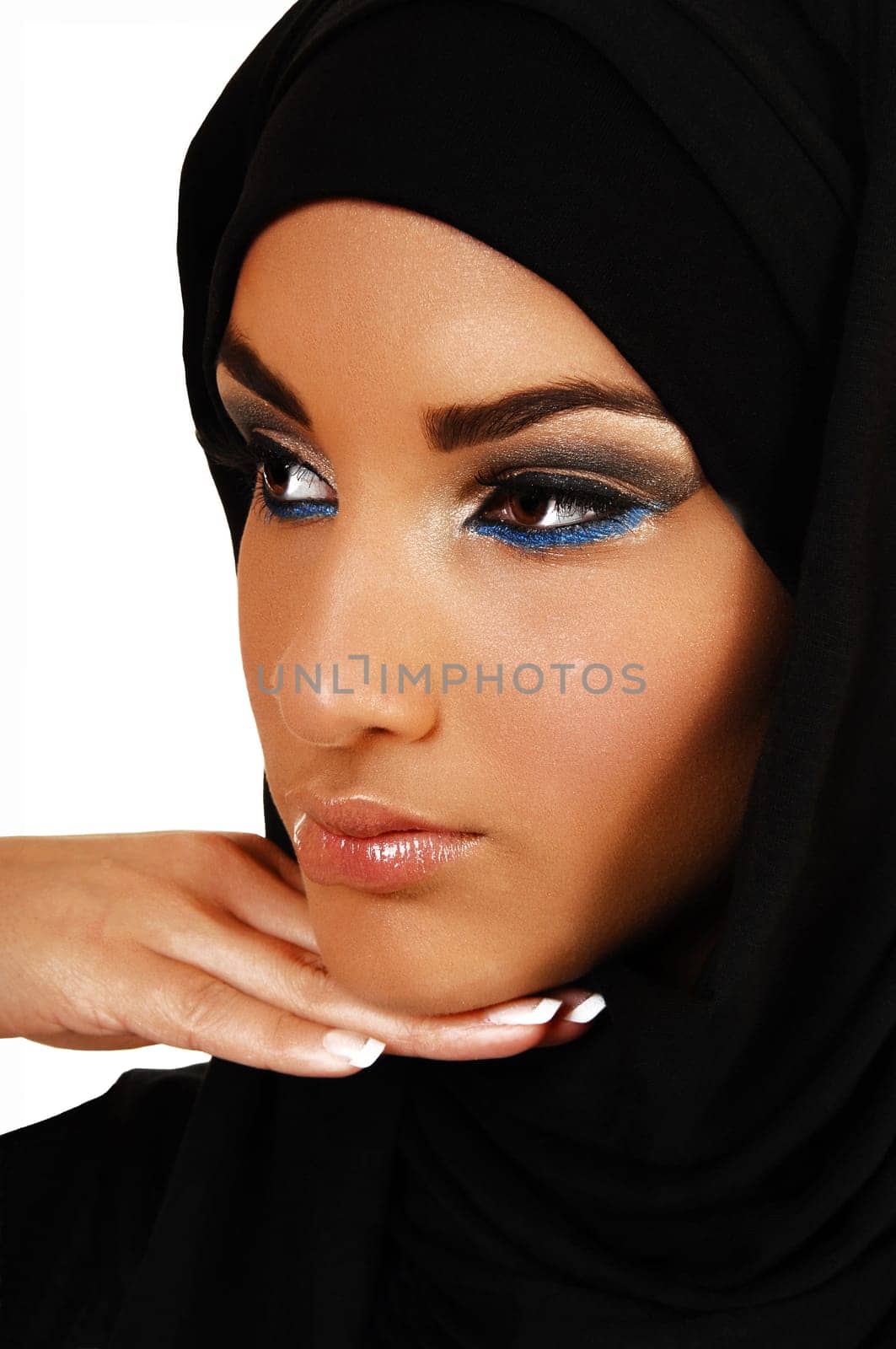 A young beautiful girl with a black headscarf and nice makeup, with her hand under her skin looking away for in closeup over white background.