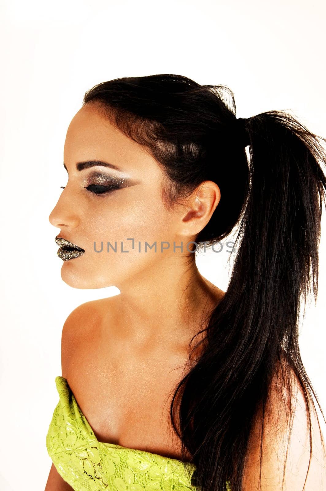A lovely  young teen girl with long black hair in a closeup shoot and a  shoulder less top and black lips for white background.