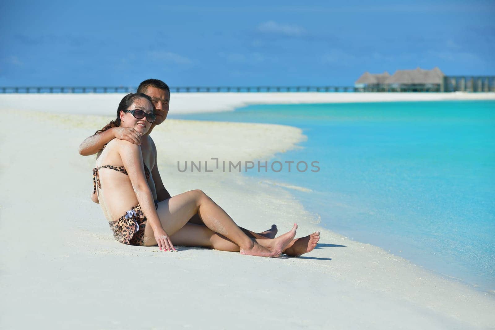 happy young asian couple have fun and romantic time at  summer on beautiful white sand beach
