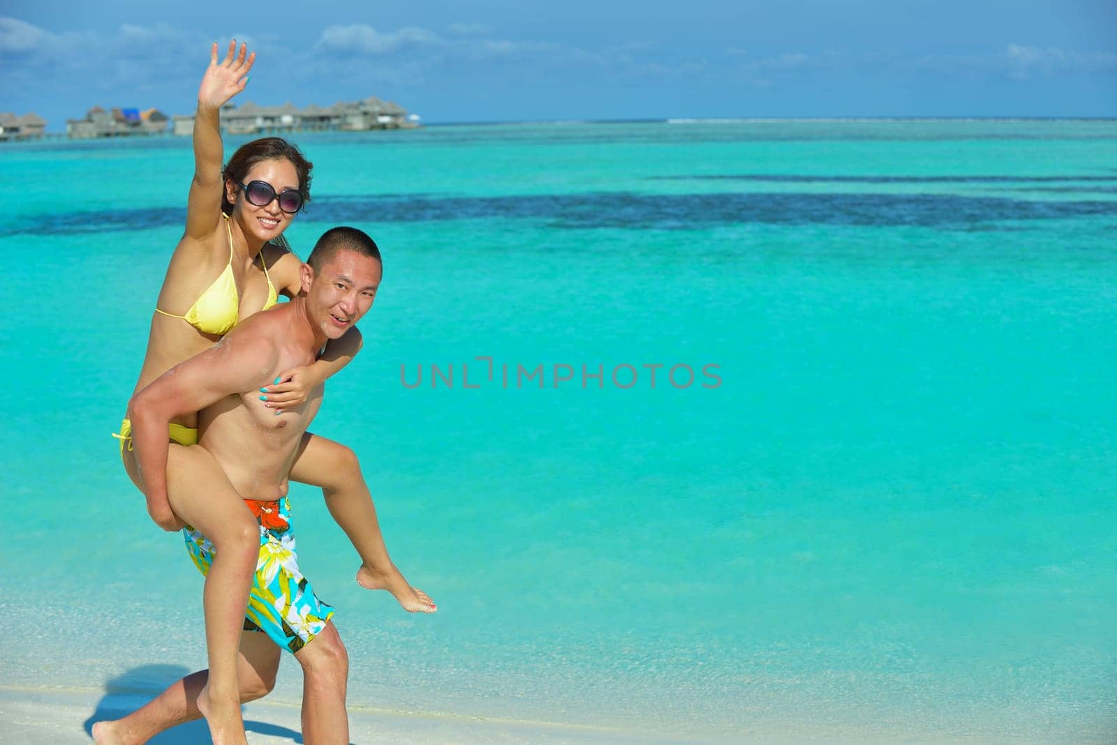 happy young asian couple have fun and romantic time at  summer on beautiful white sand beach