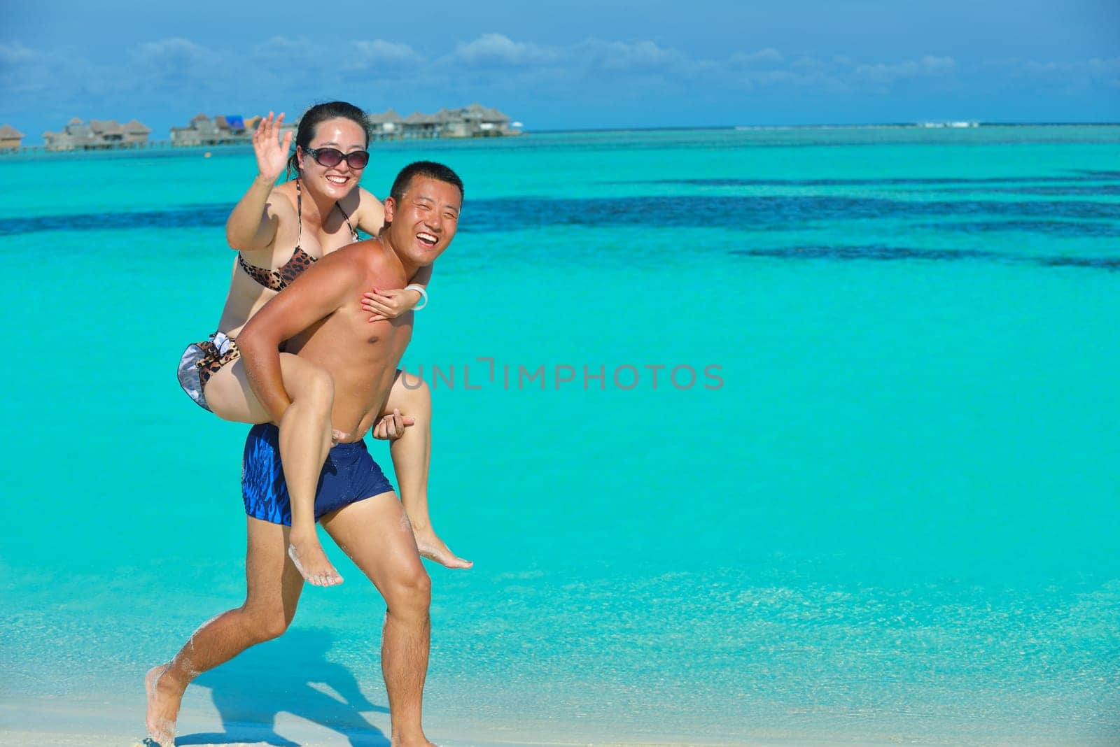happy young asian couple have fun and romantic time at  summer on beautiful white sand beach
