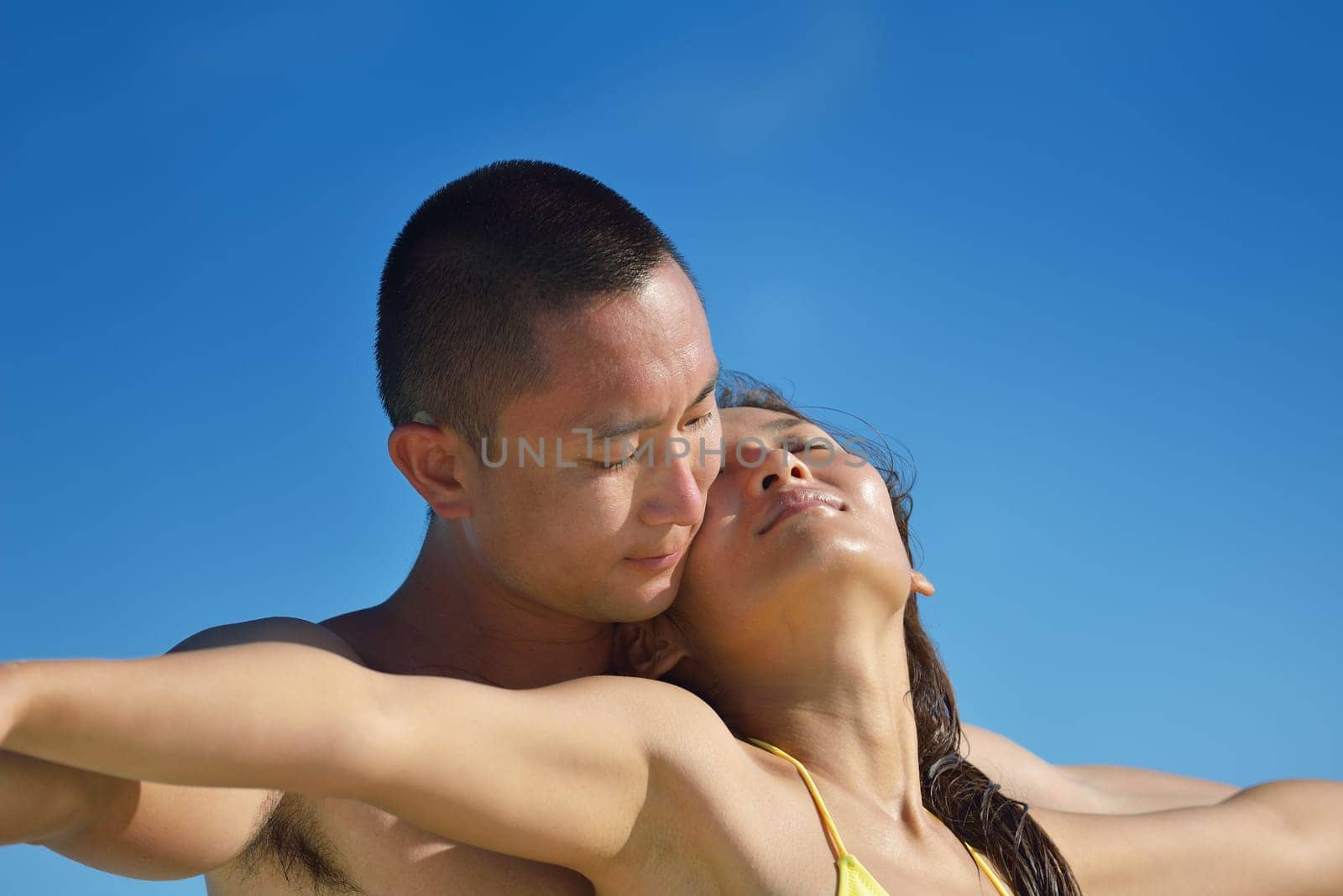 happy young asian couple have fun and romantic time at  summer on beautiful white sand beach