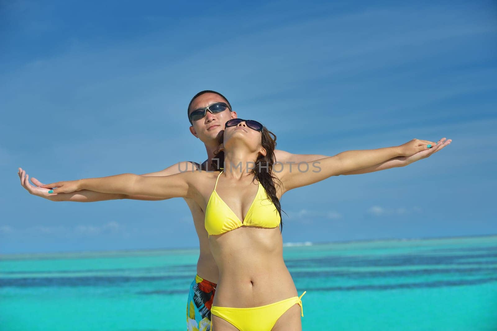 happy young asian couple have fun and romantic time at  summer on beautiful white sand beach