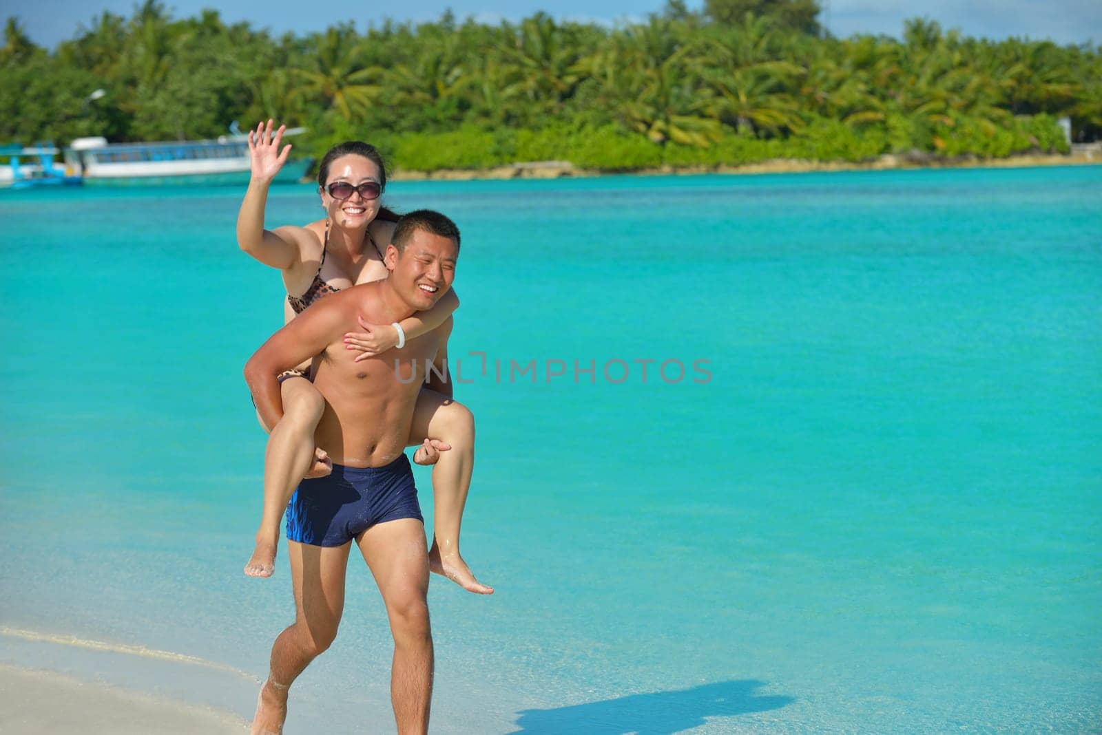 happy young asian couple have fun and romantic time at  summer on beautiful white sand beach