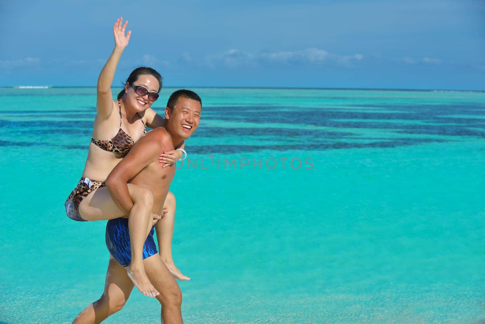 happy young asian couple have fun and romantic time at  summer on beautiful white sand beach