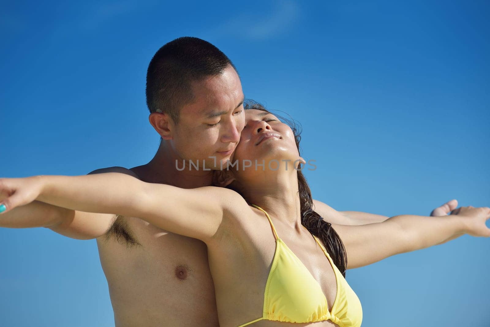 happy young asian couple have fun and romantic time at  summer on beautiful white sand beach