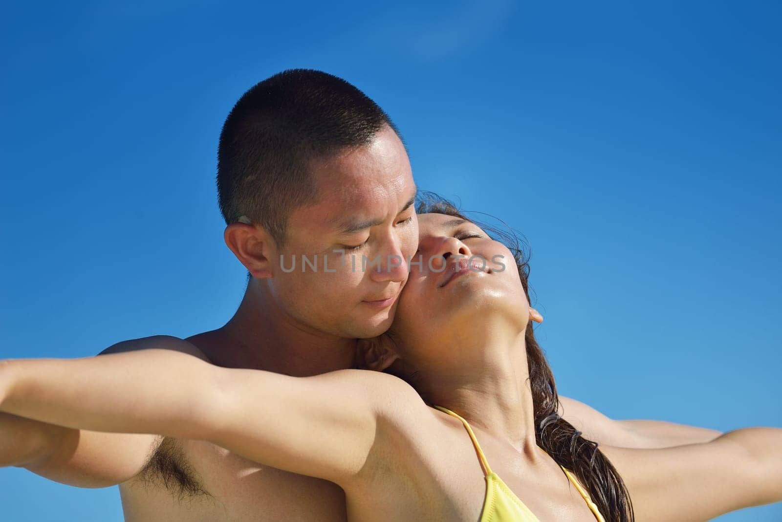 happy young asian couple have fun and romantic time at  summer on beautiful white sand beach