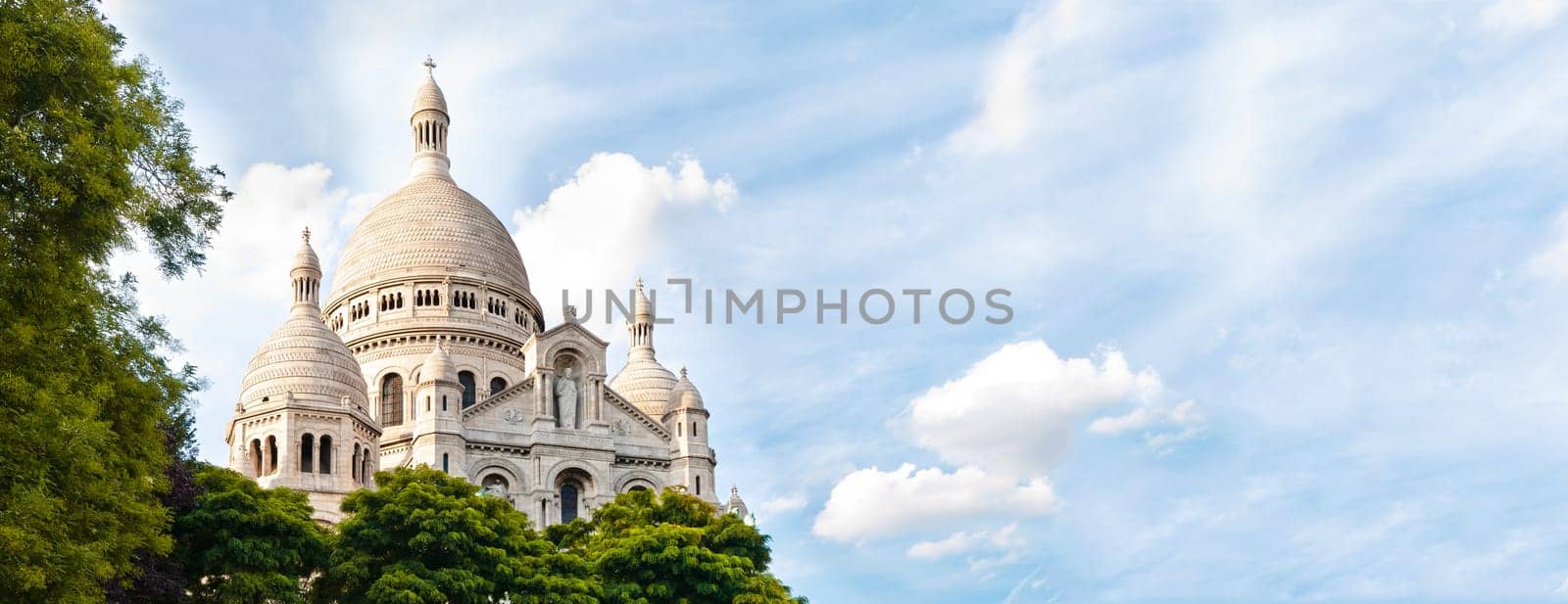 Panoramic view of Basilica of the Sacred Heart of Paris with blue cloudy sky in background (Paris, France, Europe).