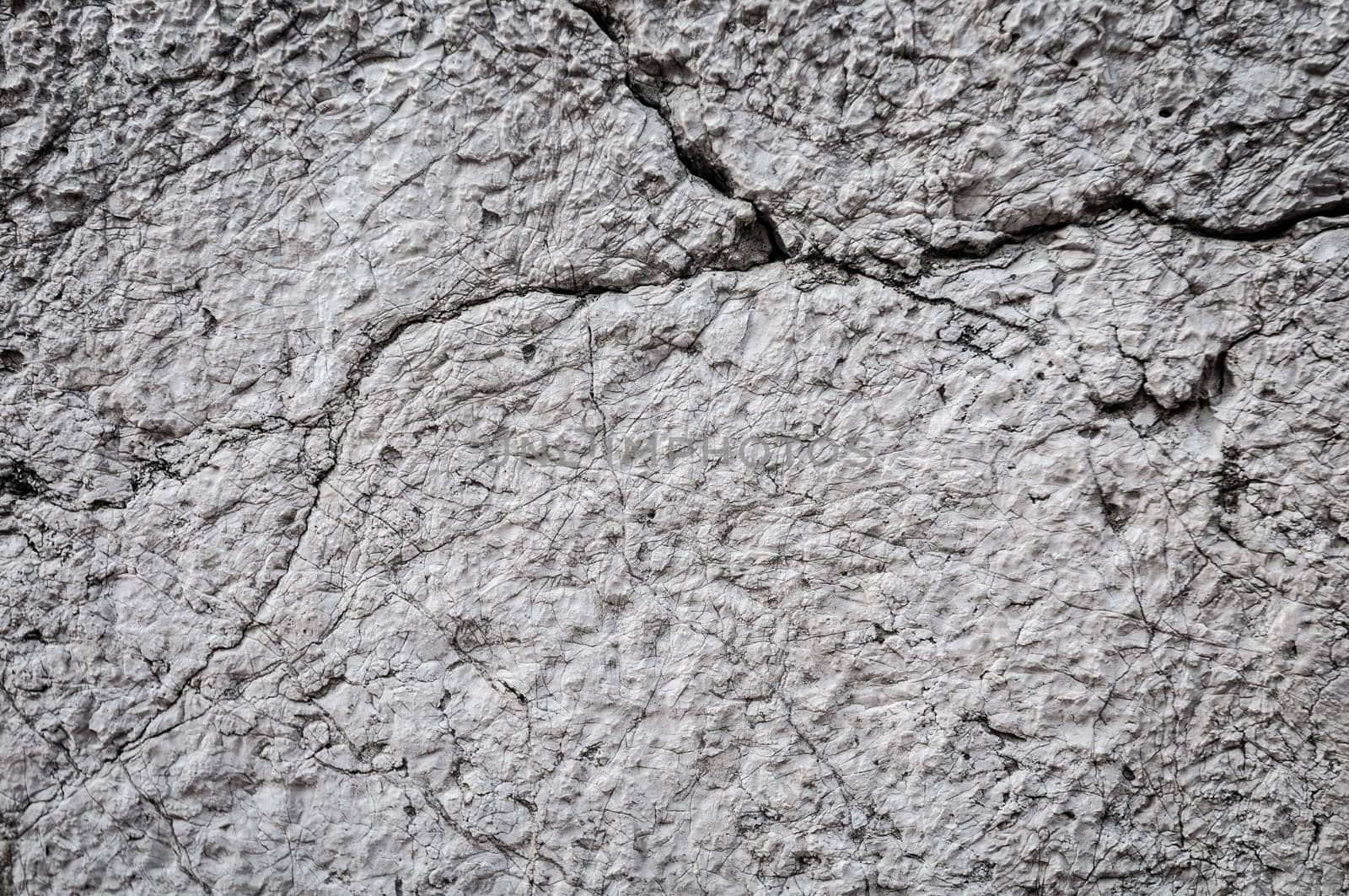 concrete wall background with cracks. Lots of detail, texture and copy space.