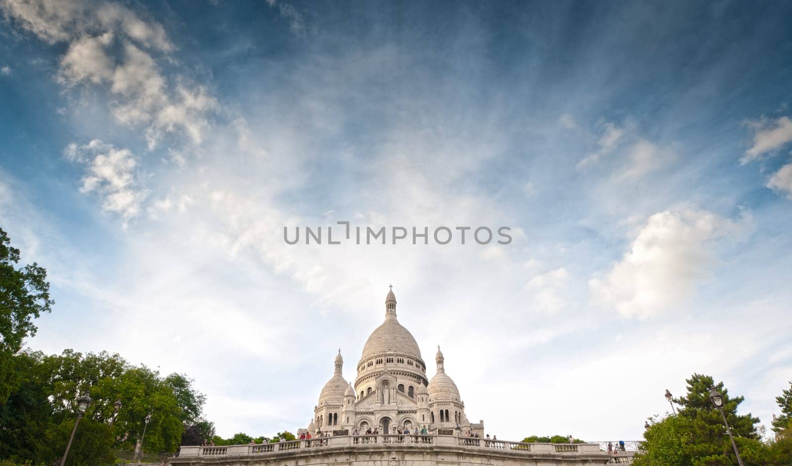 Wide view of Basilica of the Sacred Heart of Paris with blue cloudy sky (Paris, France, Europe).