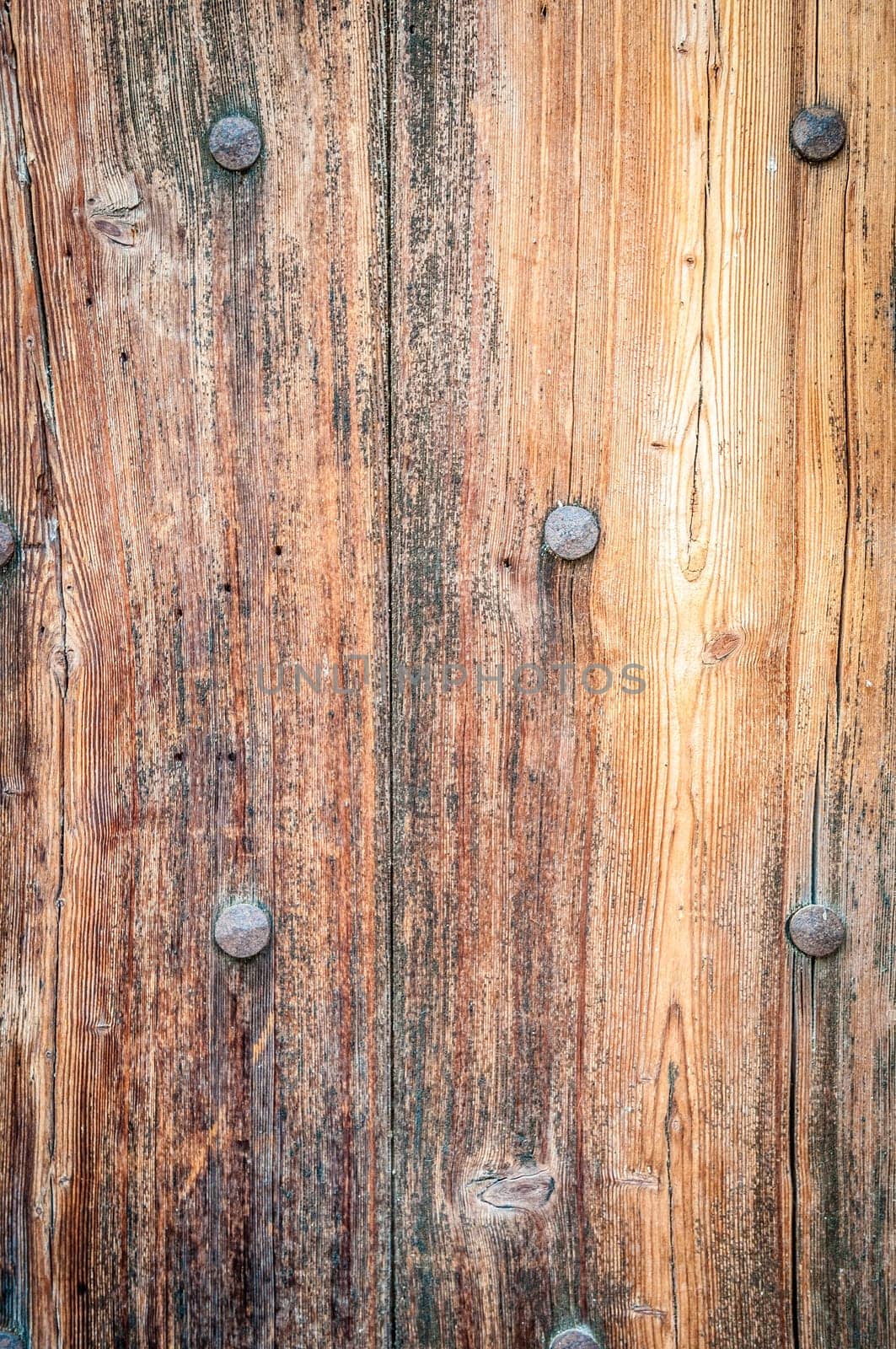 old wood background with metal nails in it. Lots of detail, texture and copy space
