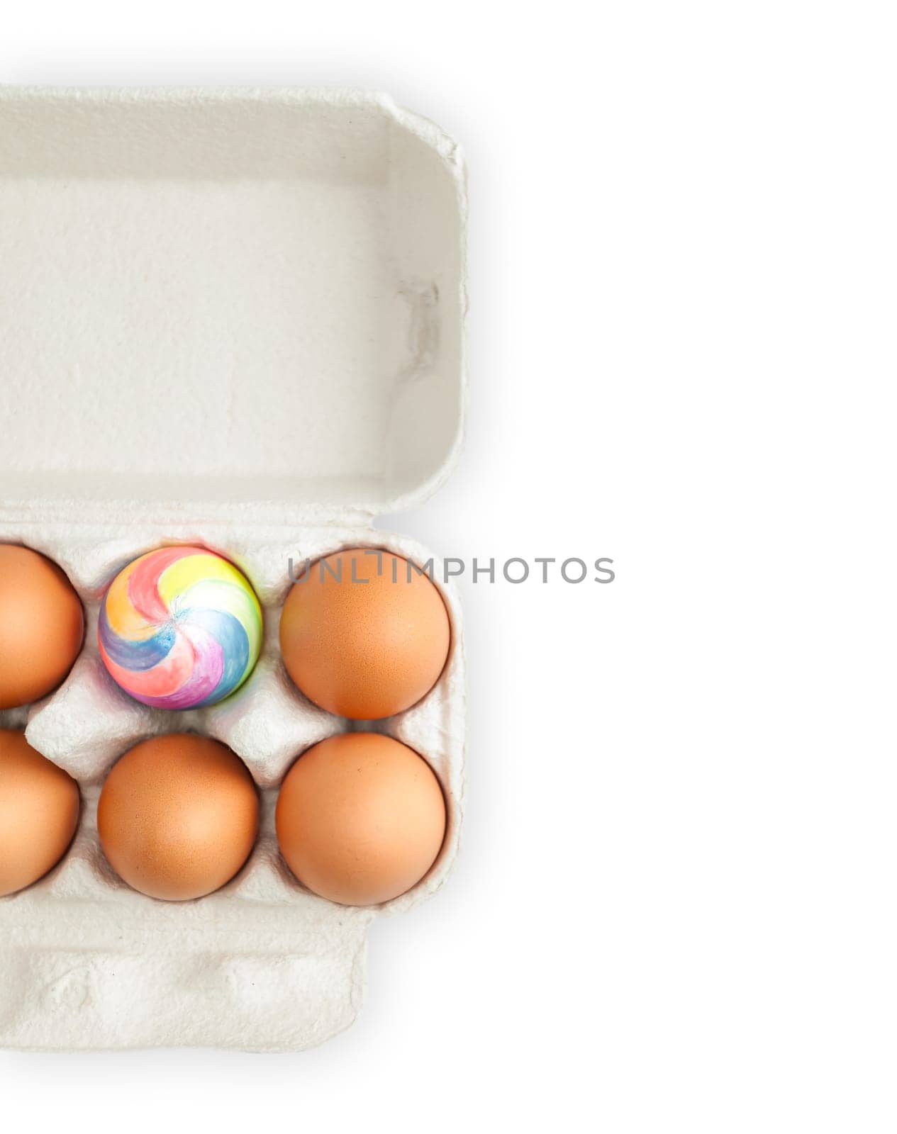 colorful painted easter egg in crate with ordinary eggs.  Isolated on white background. A lot of copy space.