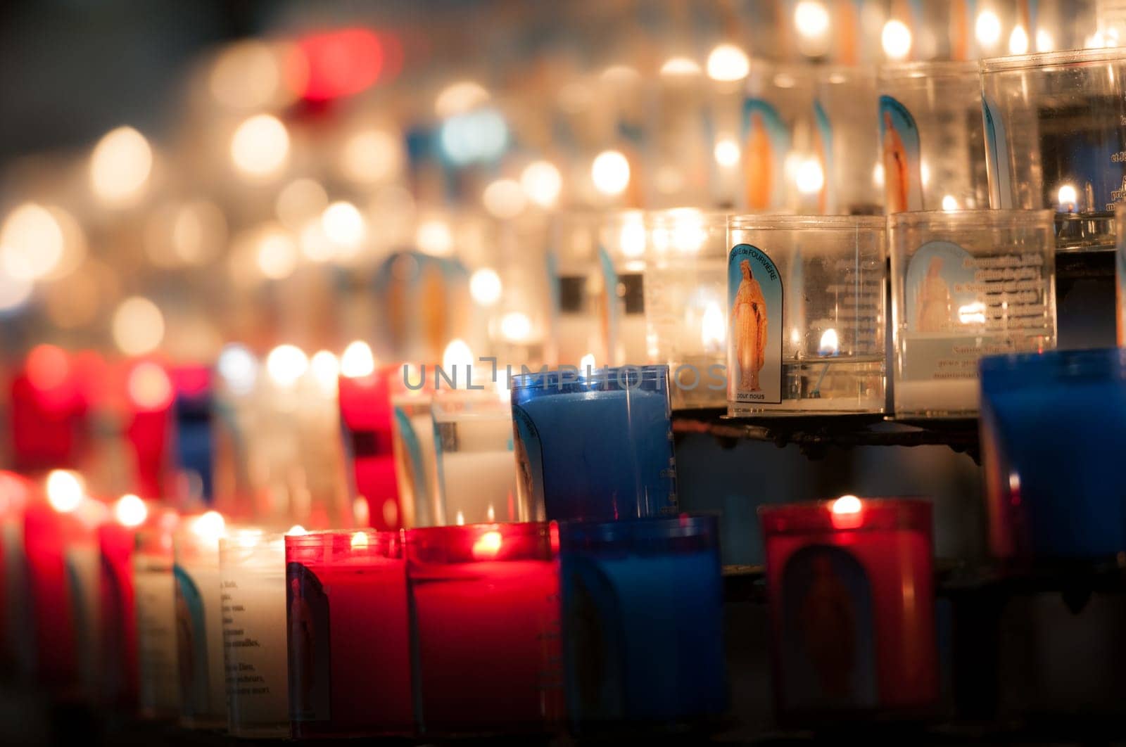 Rows of candles in catholic church in Lyon, France, Europe.