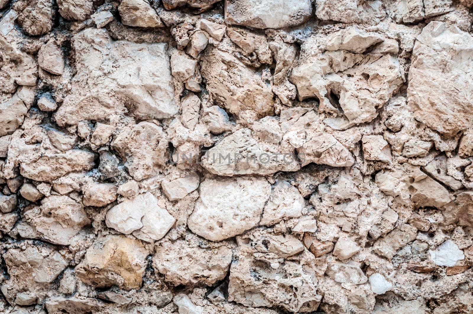 Ancient wall made of stones background. Rich detail and texture, lots of copy space.