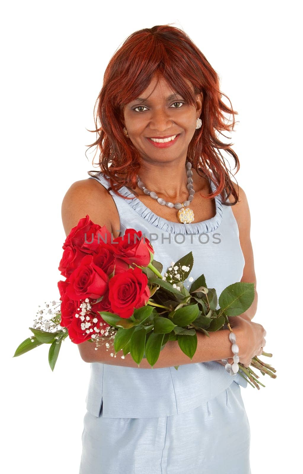 An happy african american woman is posing with her roses.
