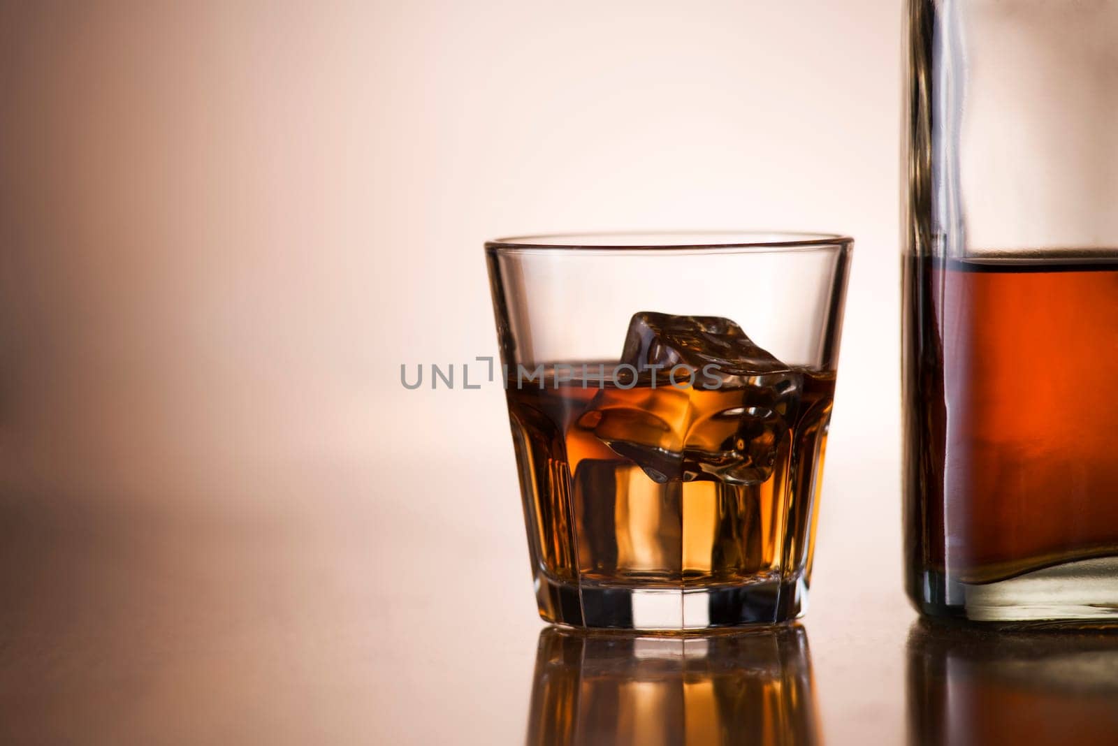 Glass of whiskey and bottle close up shoot