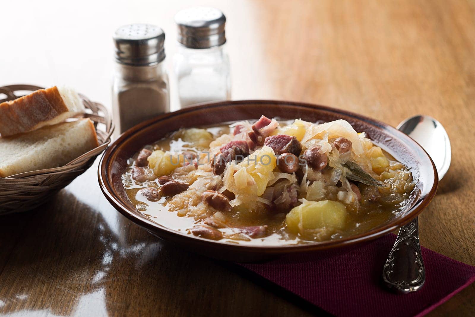 Fresh cabbage stew with potatoes, meat and beans close up