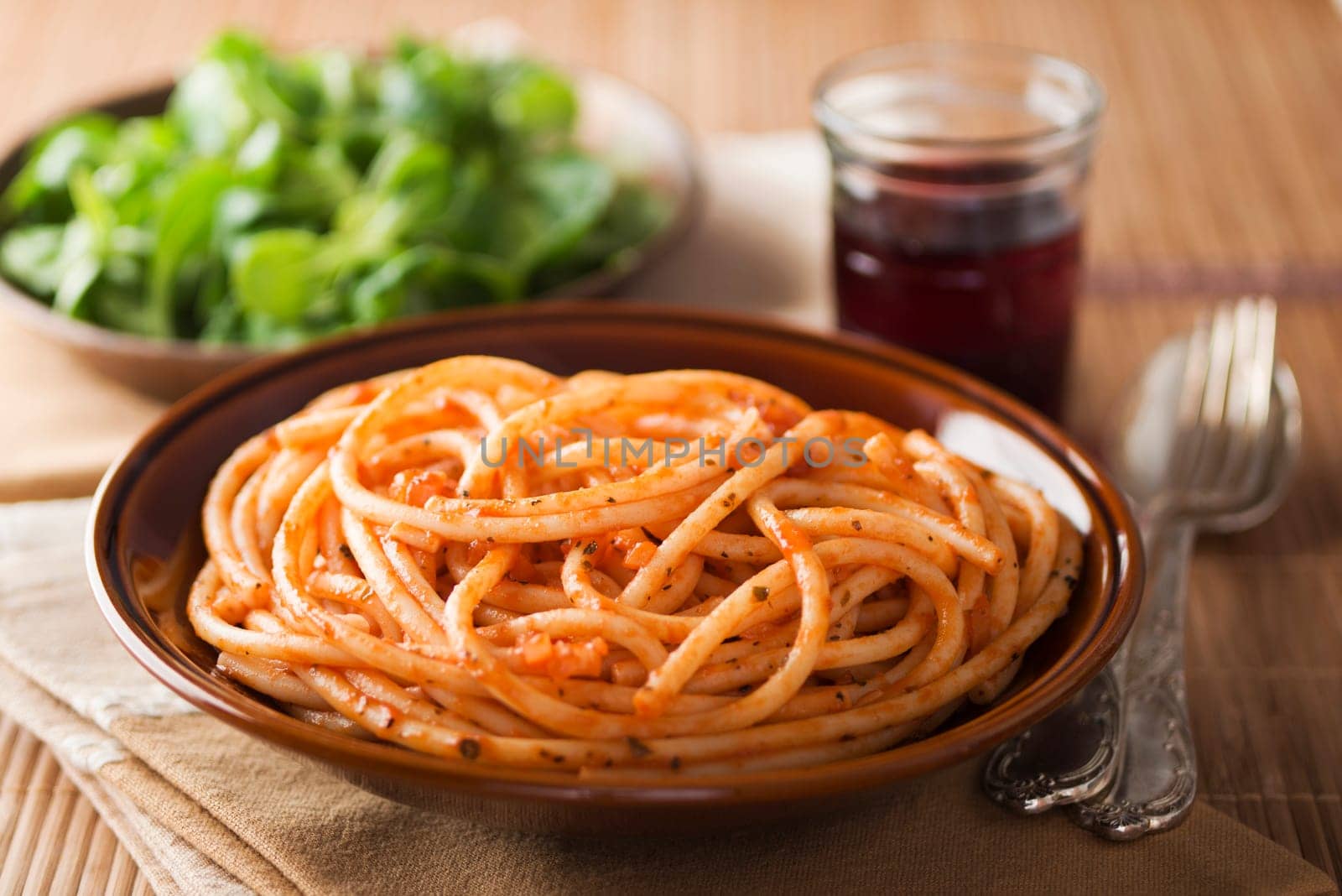 Fresh spaghetti with tomato sauce on a plate close up