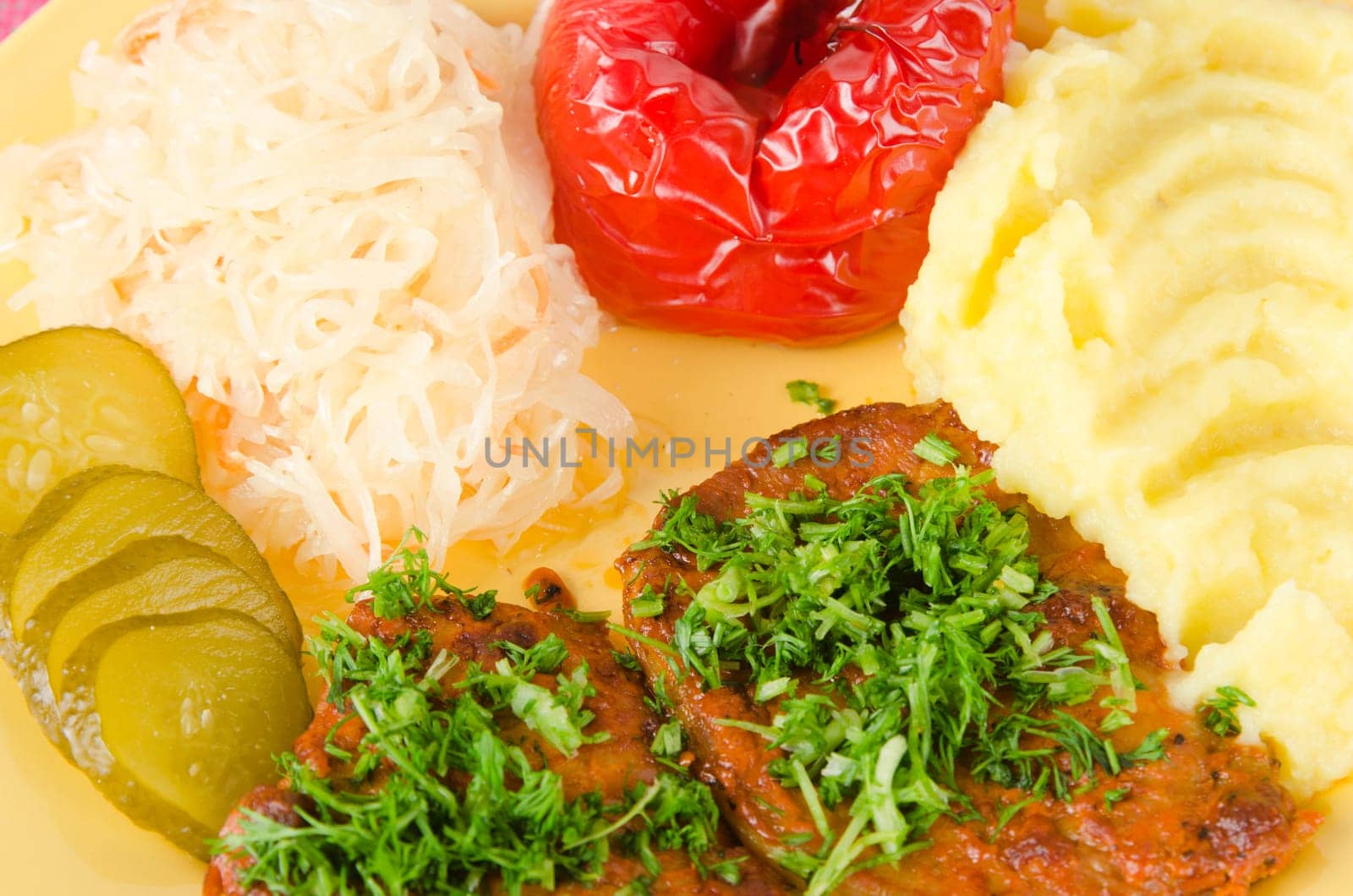 Stewed meat with vegetables on a garnish