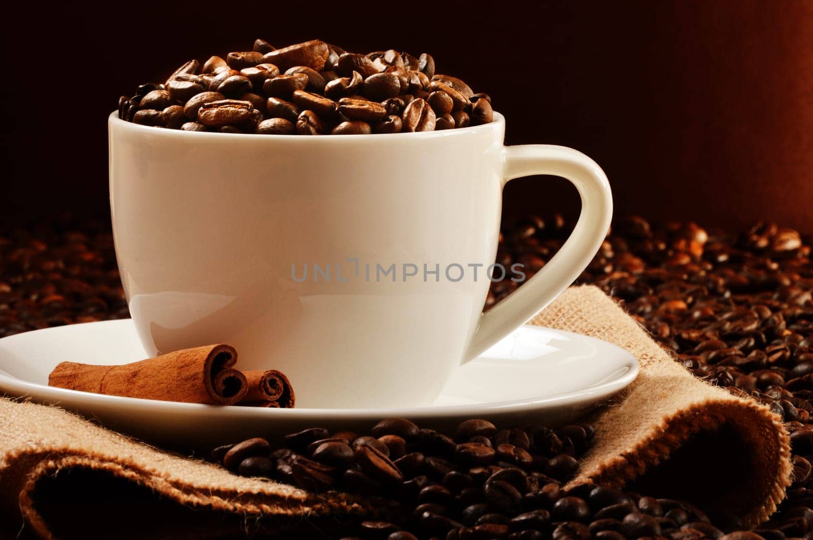 Composition with white cup and coffee beans
