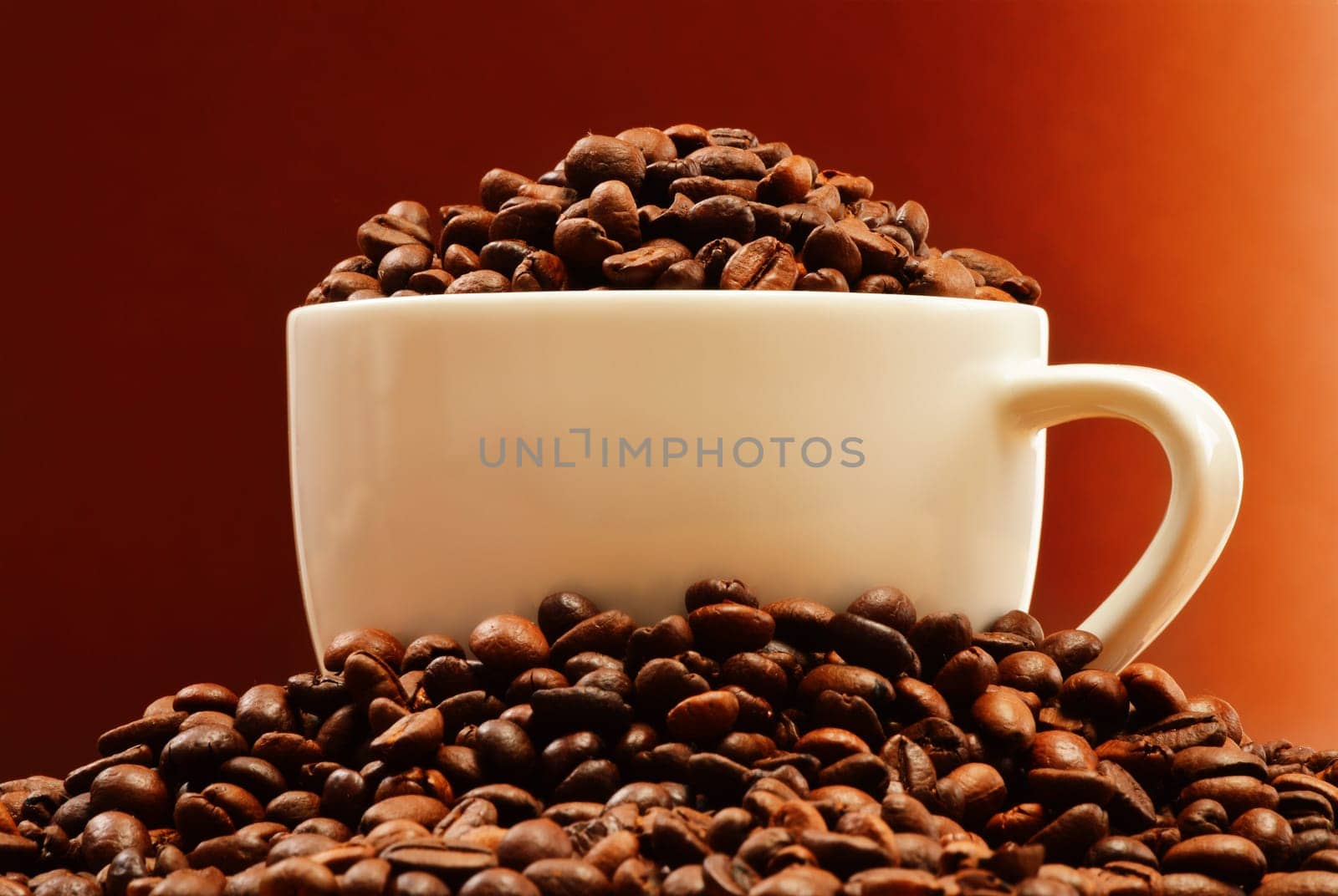 Composition with white cup and coffee beans