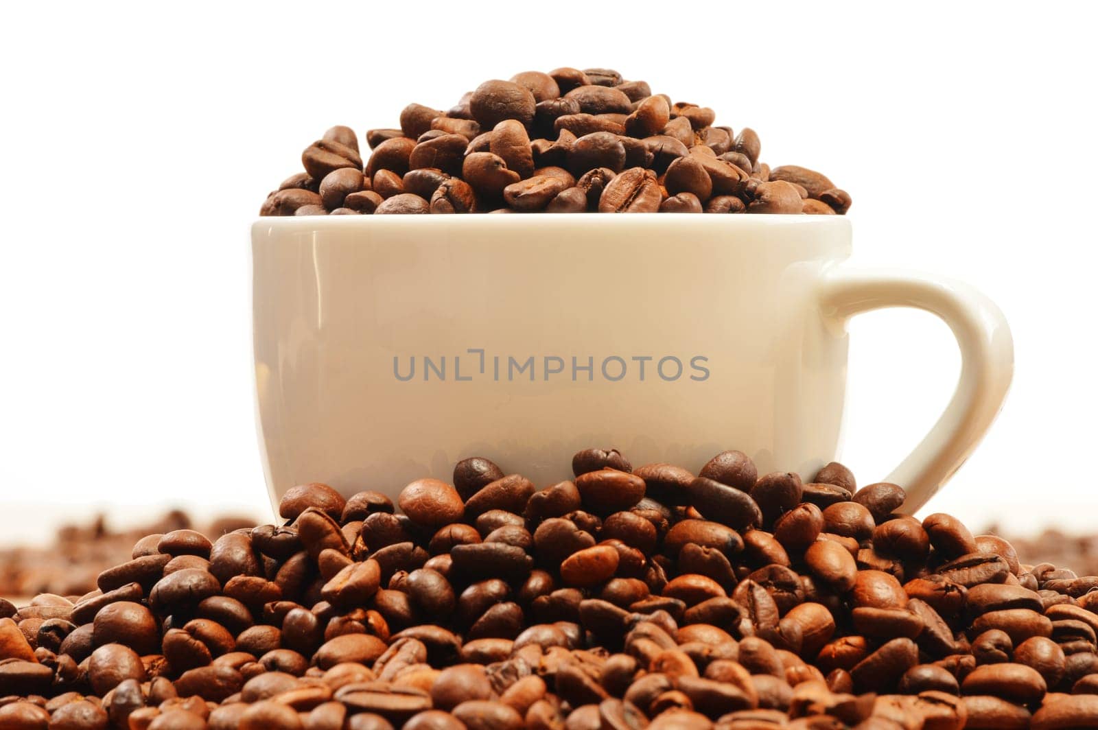 Composition with white cup and coffee beans