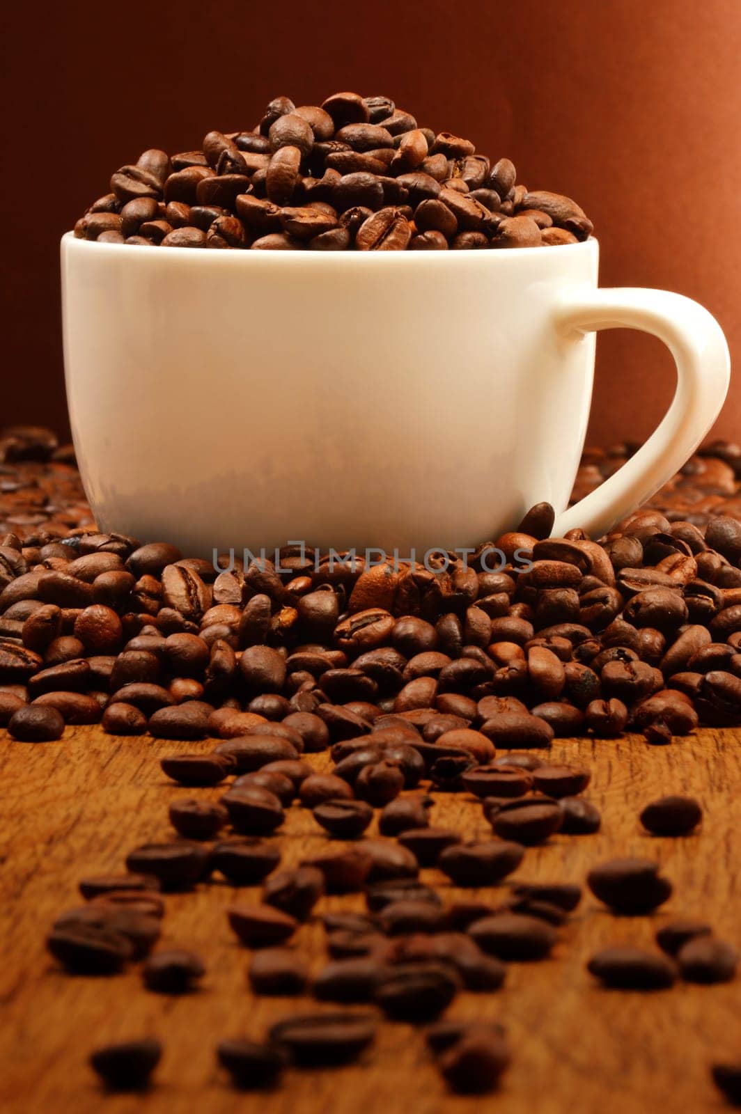 Composition with white cup and coffee beans