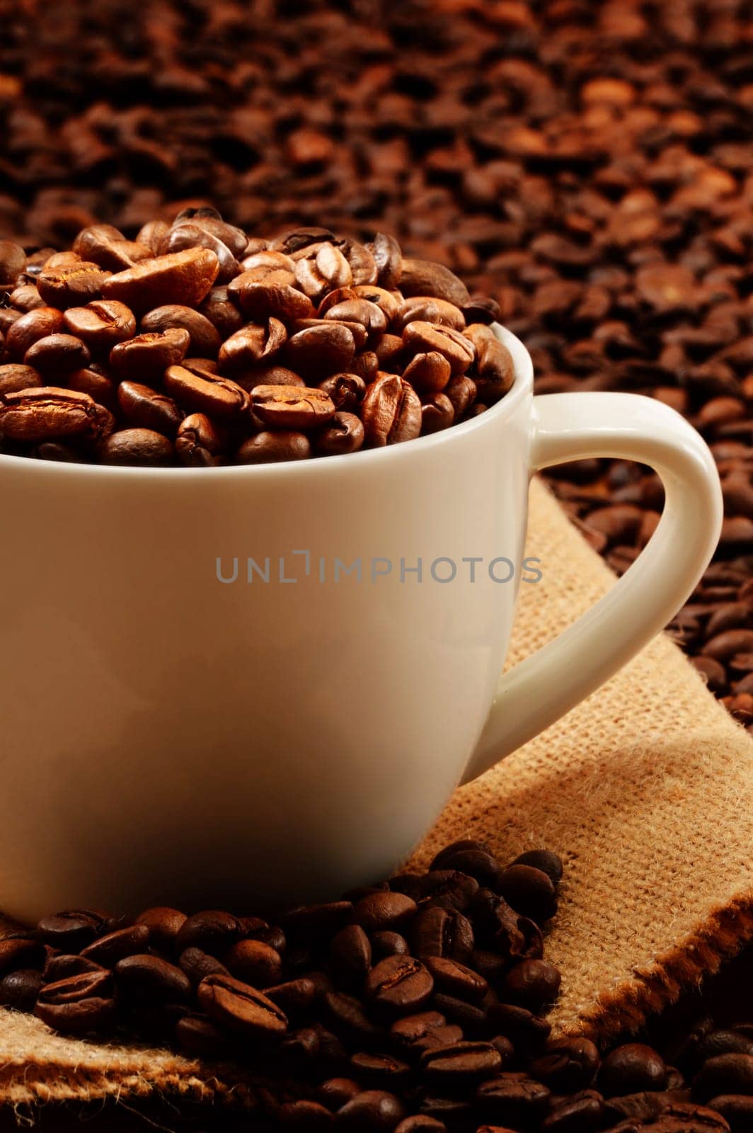 Composition with white cup and coffee beans