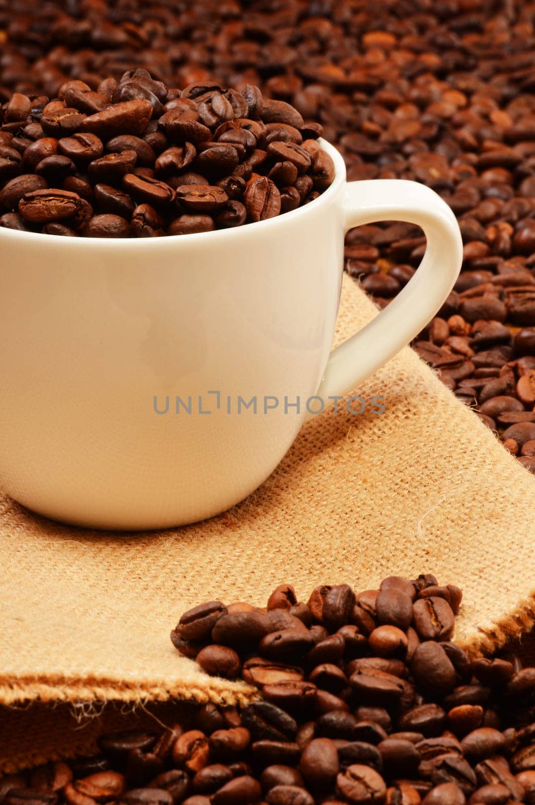 Composition with white cup and coffee beans