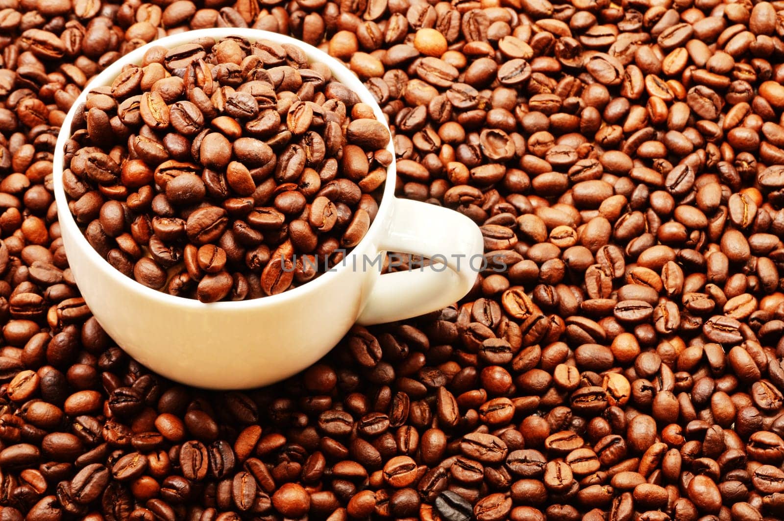 Composition with white cup and coffee beans