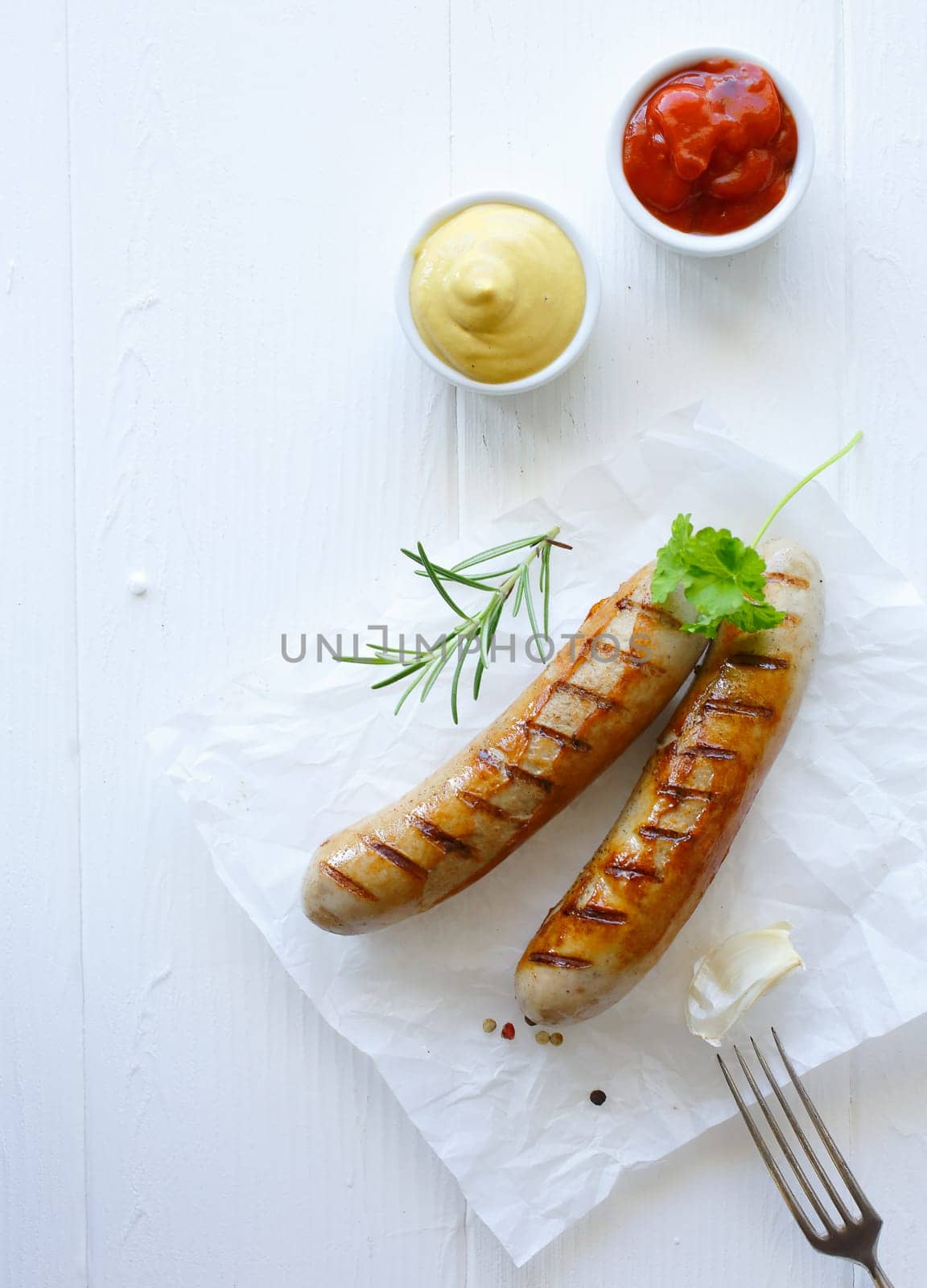 Grilled bratwurst with ketchup and mustard dip