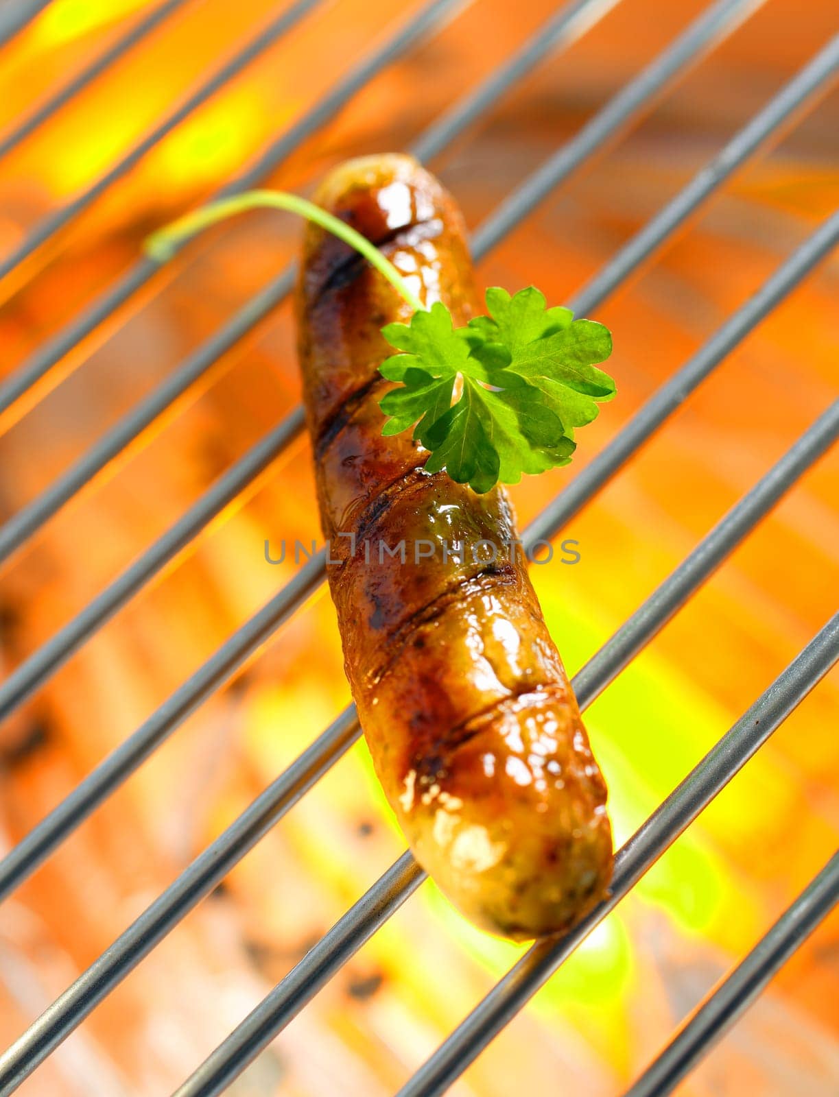 Italian grilled sausage with open flames in close up shot