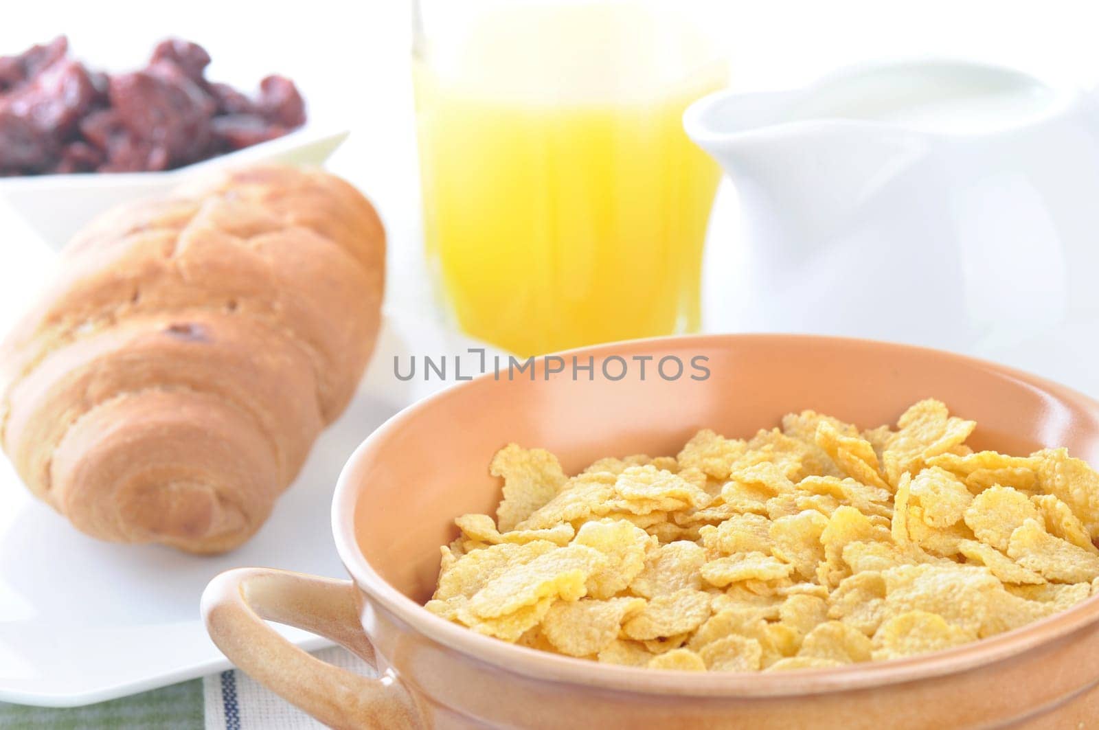 a bowl of corn flakes and milk. breakfast.