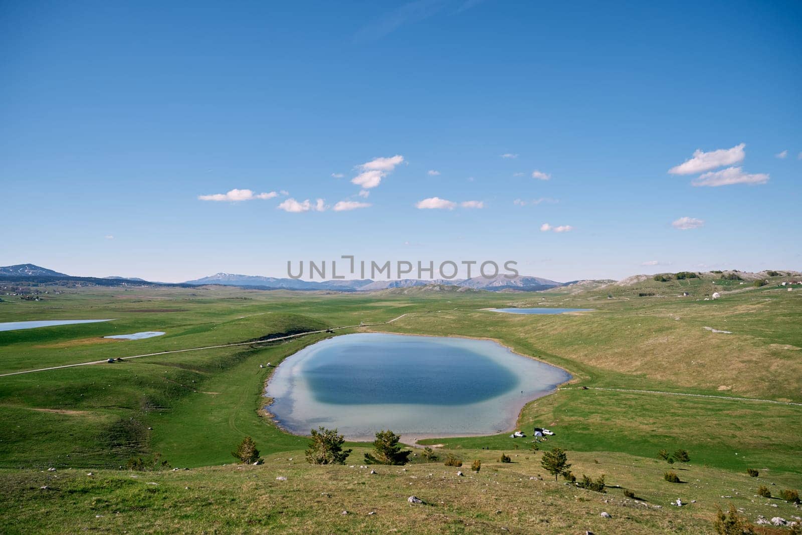 Clear blue Vrazje Lake on a green mountain valley. Montenegro. High quality photo