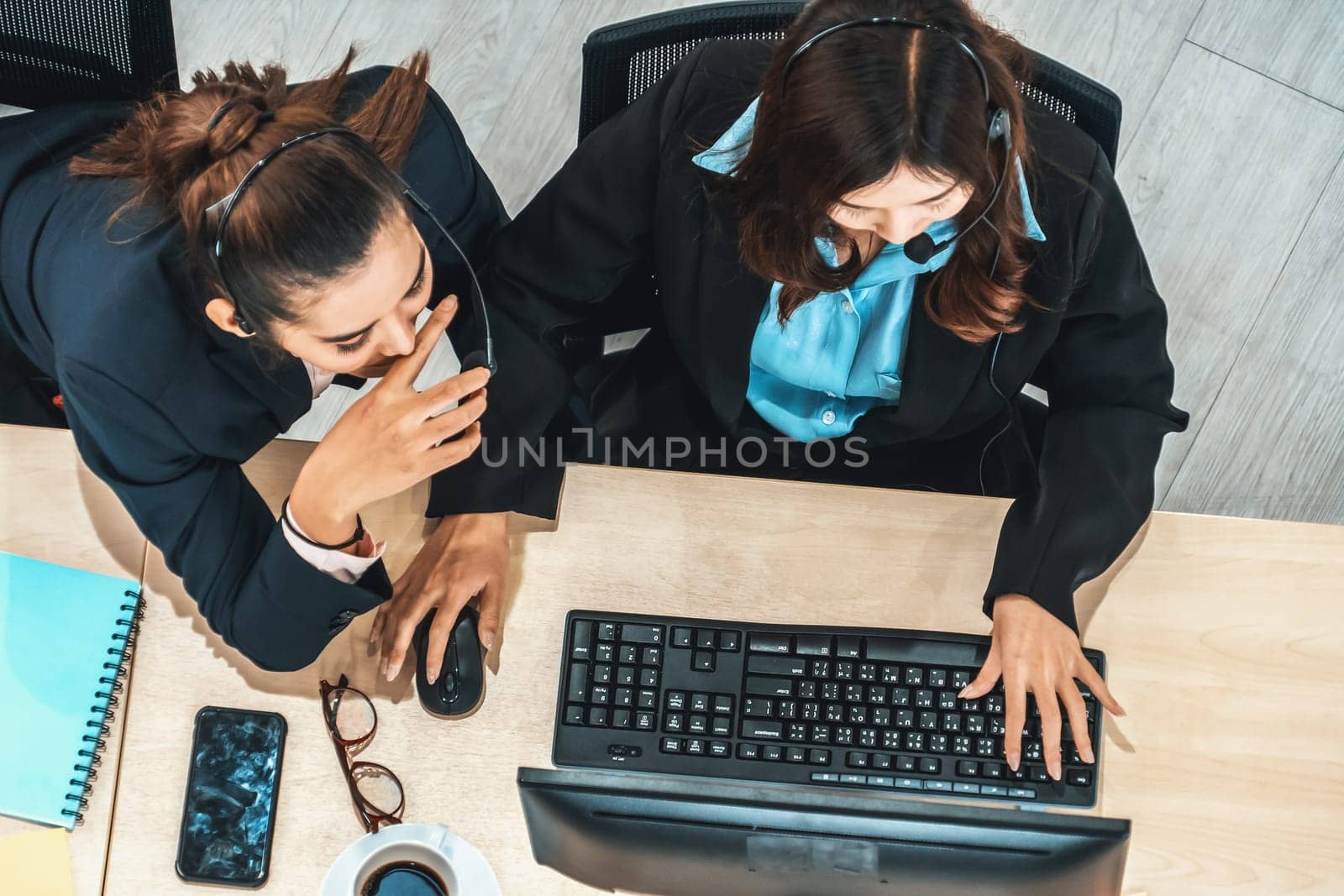 Business people wearing headset shot from top view in office working with computer. Jivy