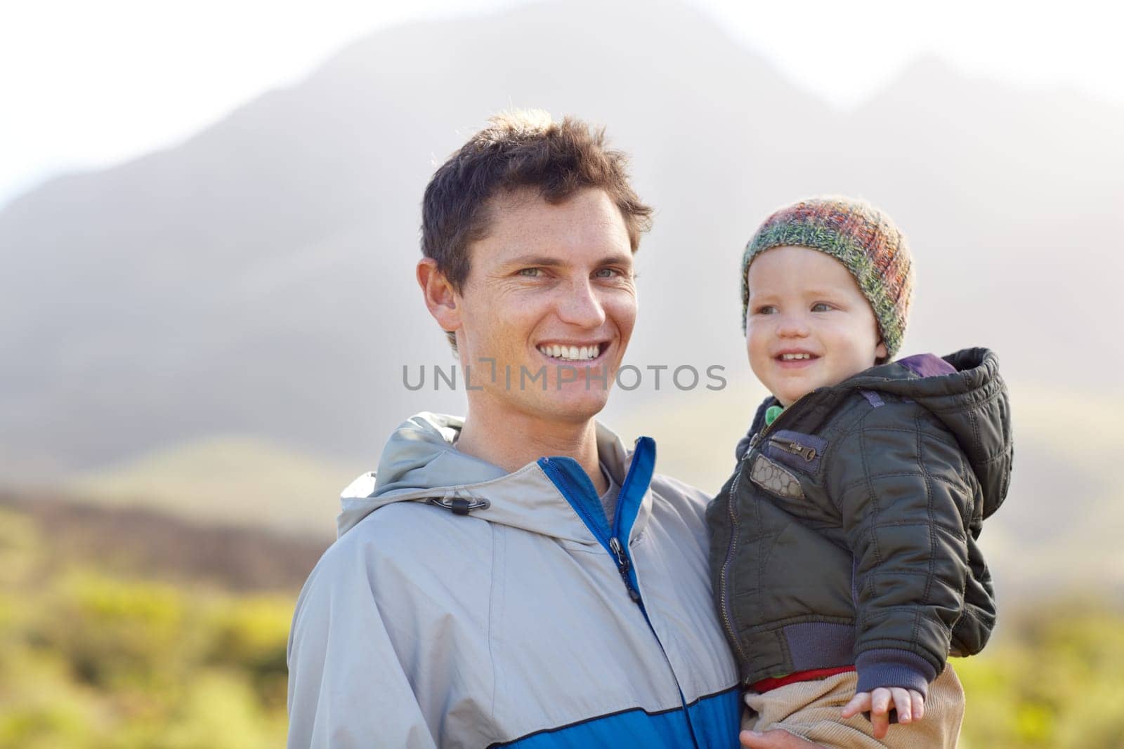 Portrait, father and child for hiking in mountains for wellness, travel or fun. Sweden, man and baby for smile, happy or excited in quality time, together and fresh air on trip for love, care or bond.