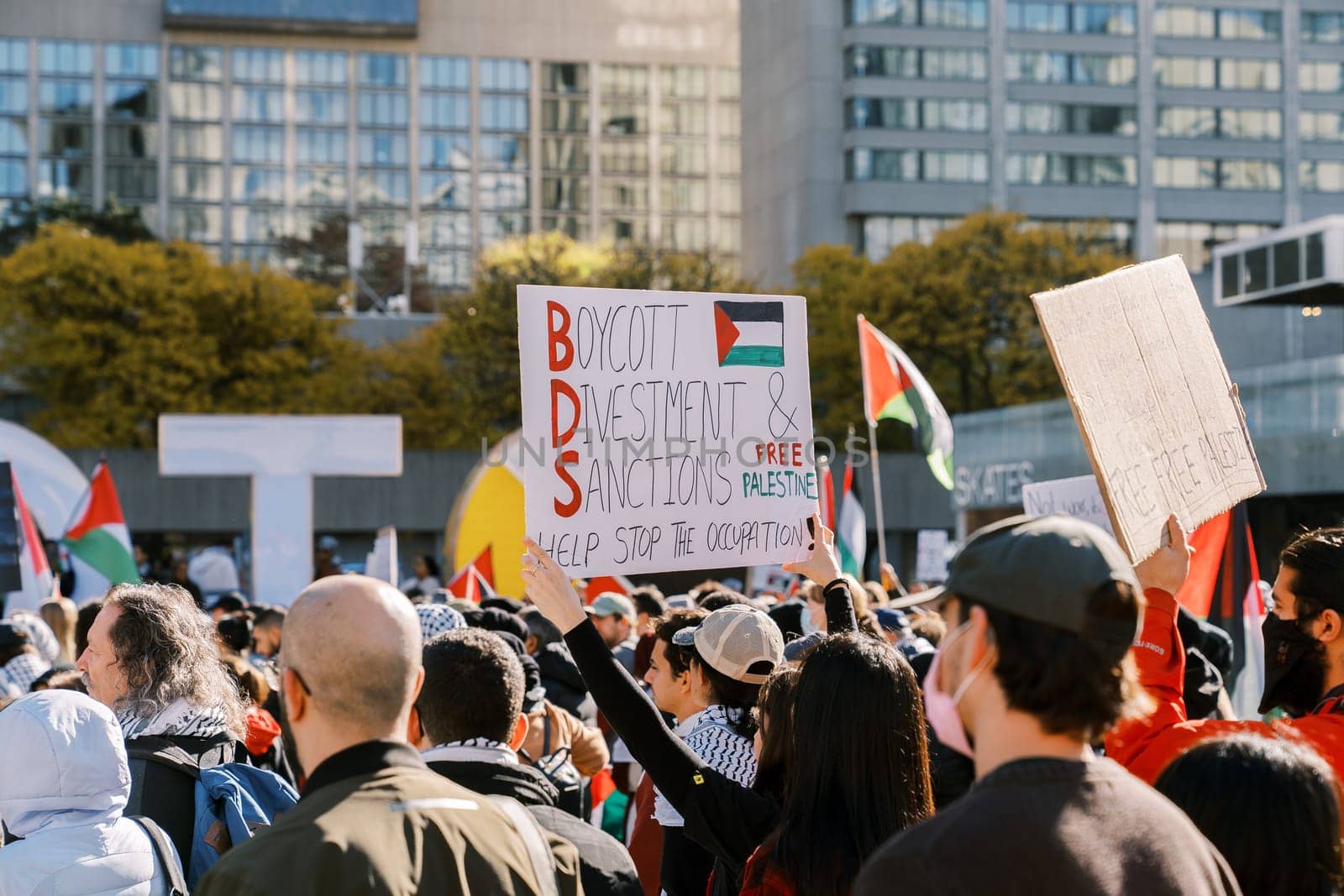 Toronto, Canada - 28 October 2023: Protesters march in the city, holding signs advocating for Boycott, Divestment, and Sanctions against the occupation and supporting Palestine. High quality photo