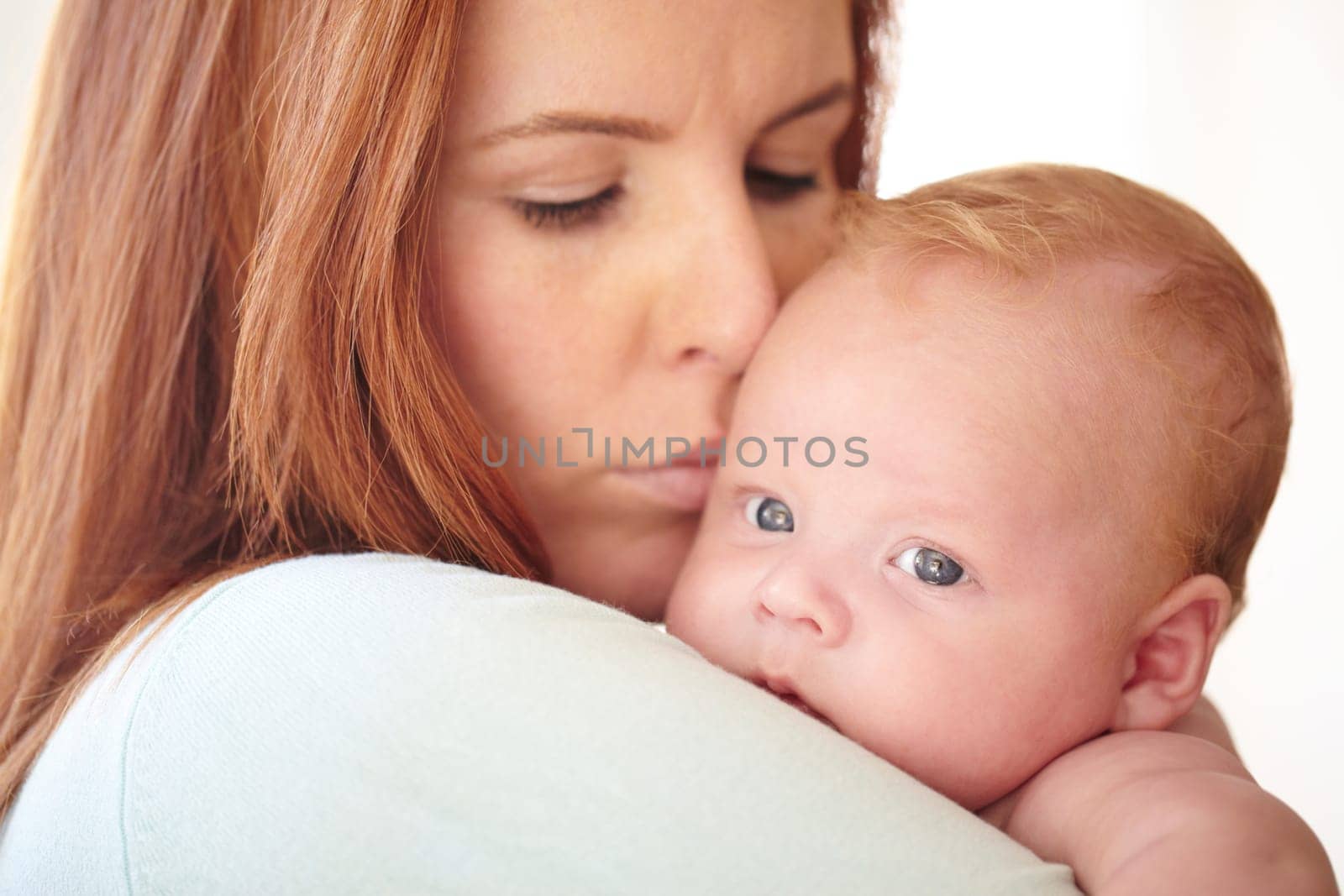 Kiss, baby and portrait with mother holding newborn in home for bonding together. Infant, face and mom carrying infant child in arms to relax in house with love, care and support with mommy by YuriArcurs