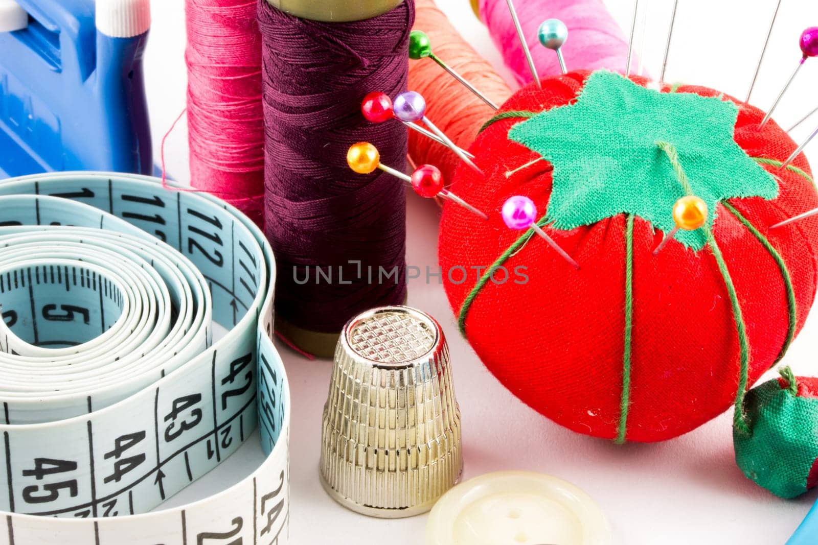 Some sewing supplies with pin, tape and meter