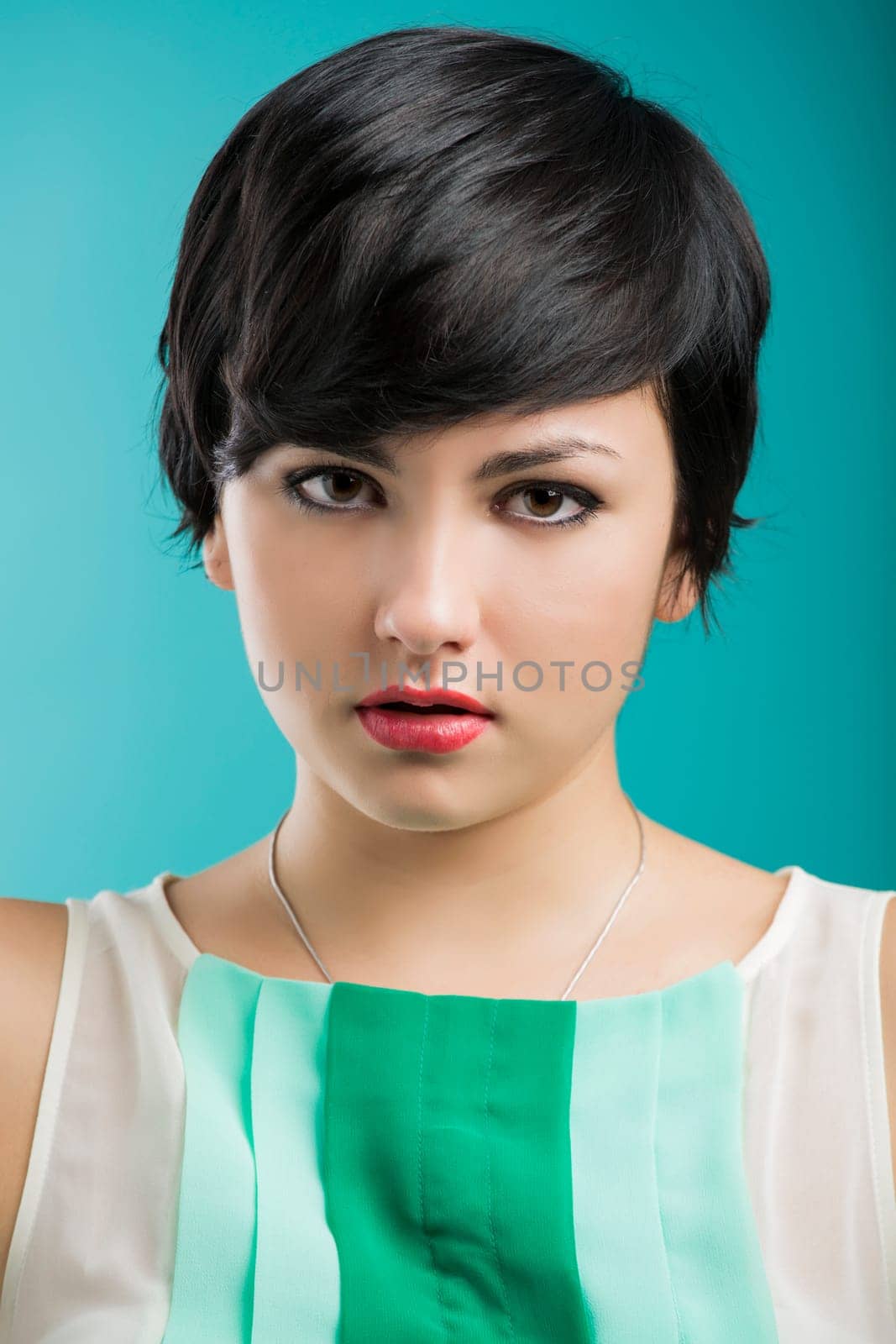 Portrait of a beautiful and fashion woman aganist a blue background