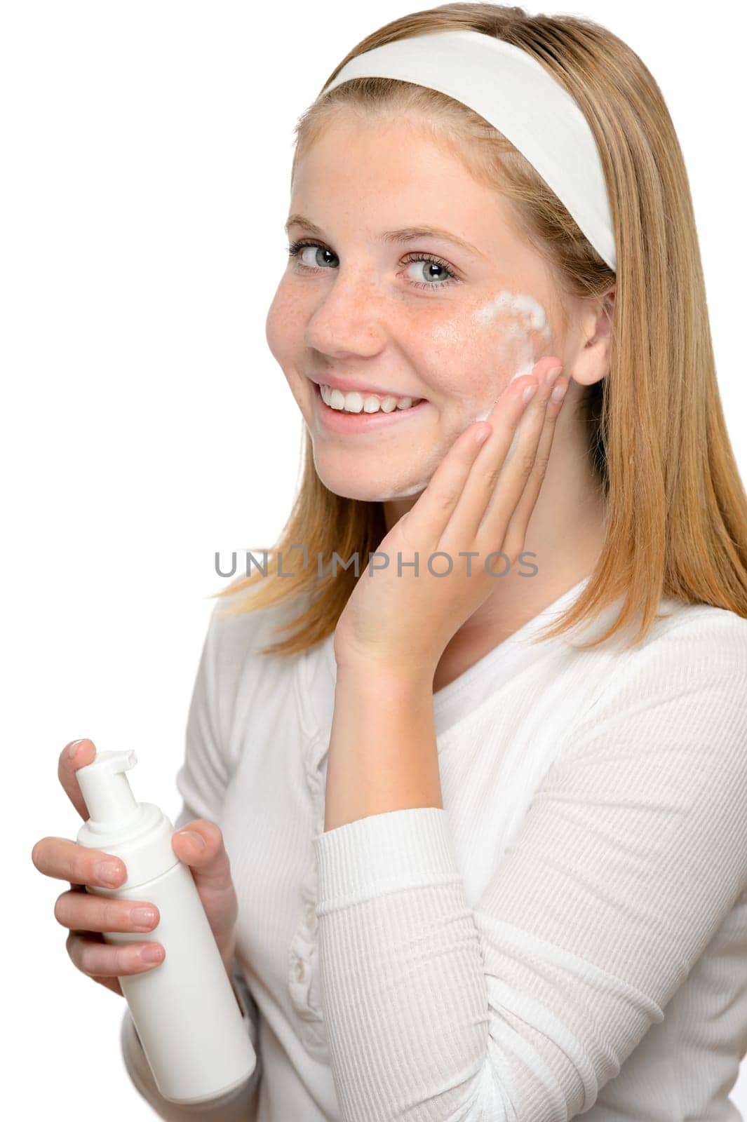 Teenager girl smiling applying moisturizer lotion face skin treatment