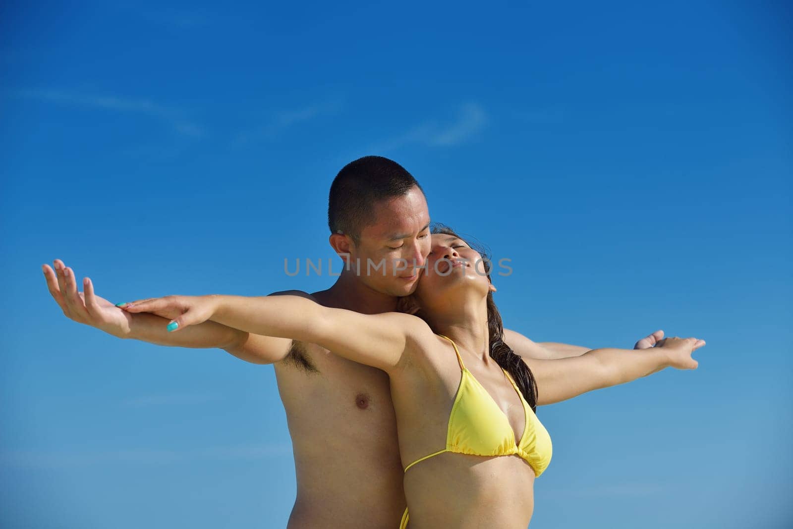 happy young asian couple have fun and romantic time at  summer on beautiful white sand beach