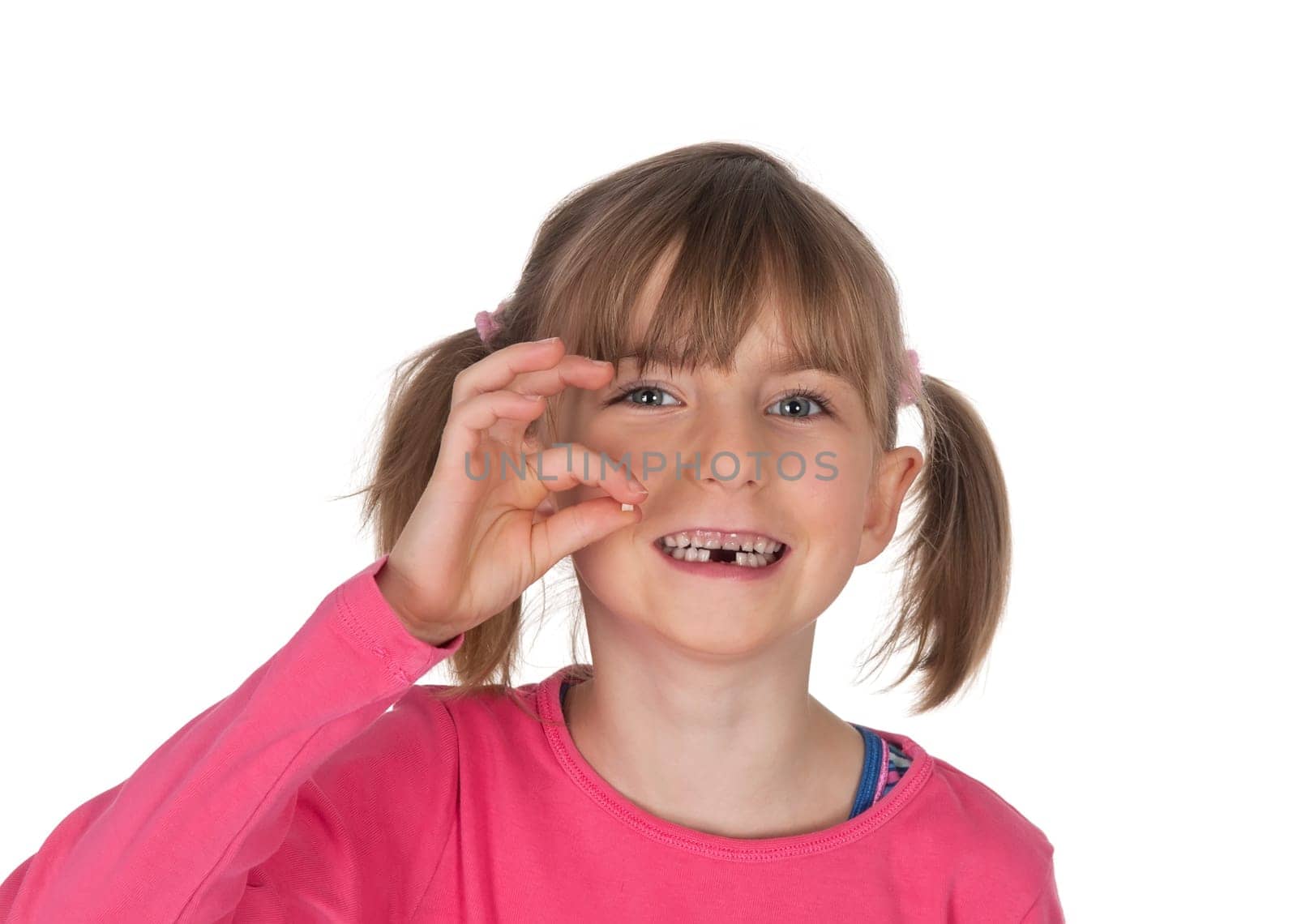 Girl shows baby tooth