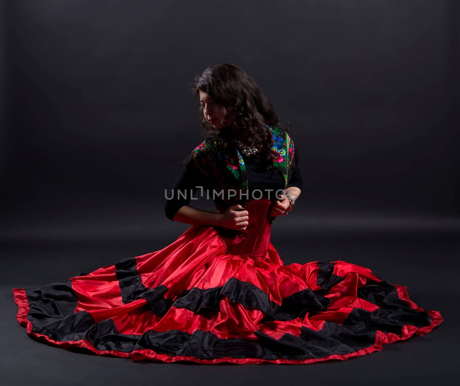 Young woman stretches back in spanish traditional clothes